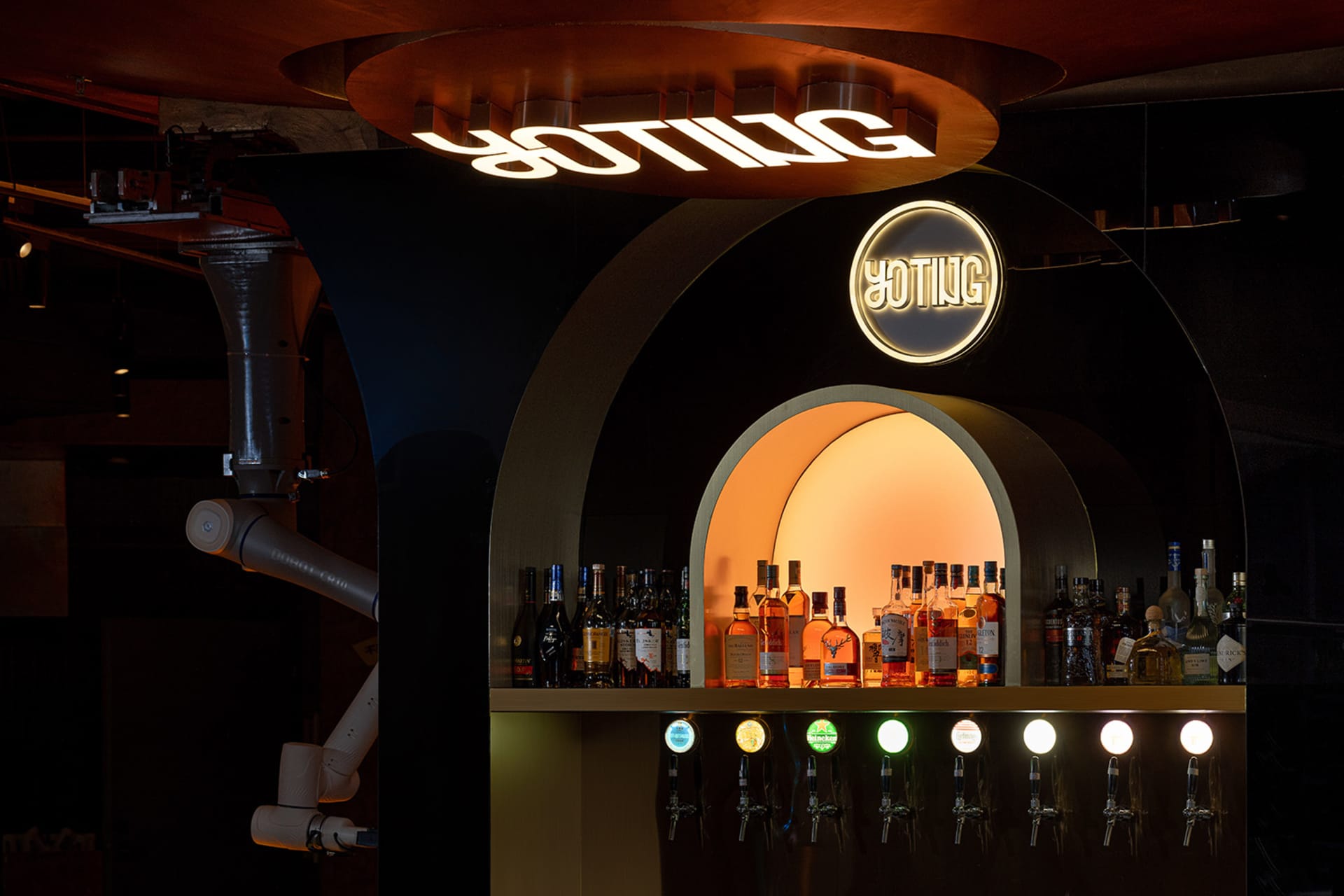A well-stocked bar area with a variety of bottles displayed on the countertop, creating a casual and inviting atmosphere for patrons