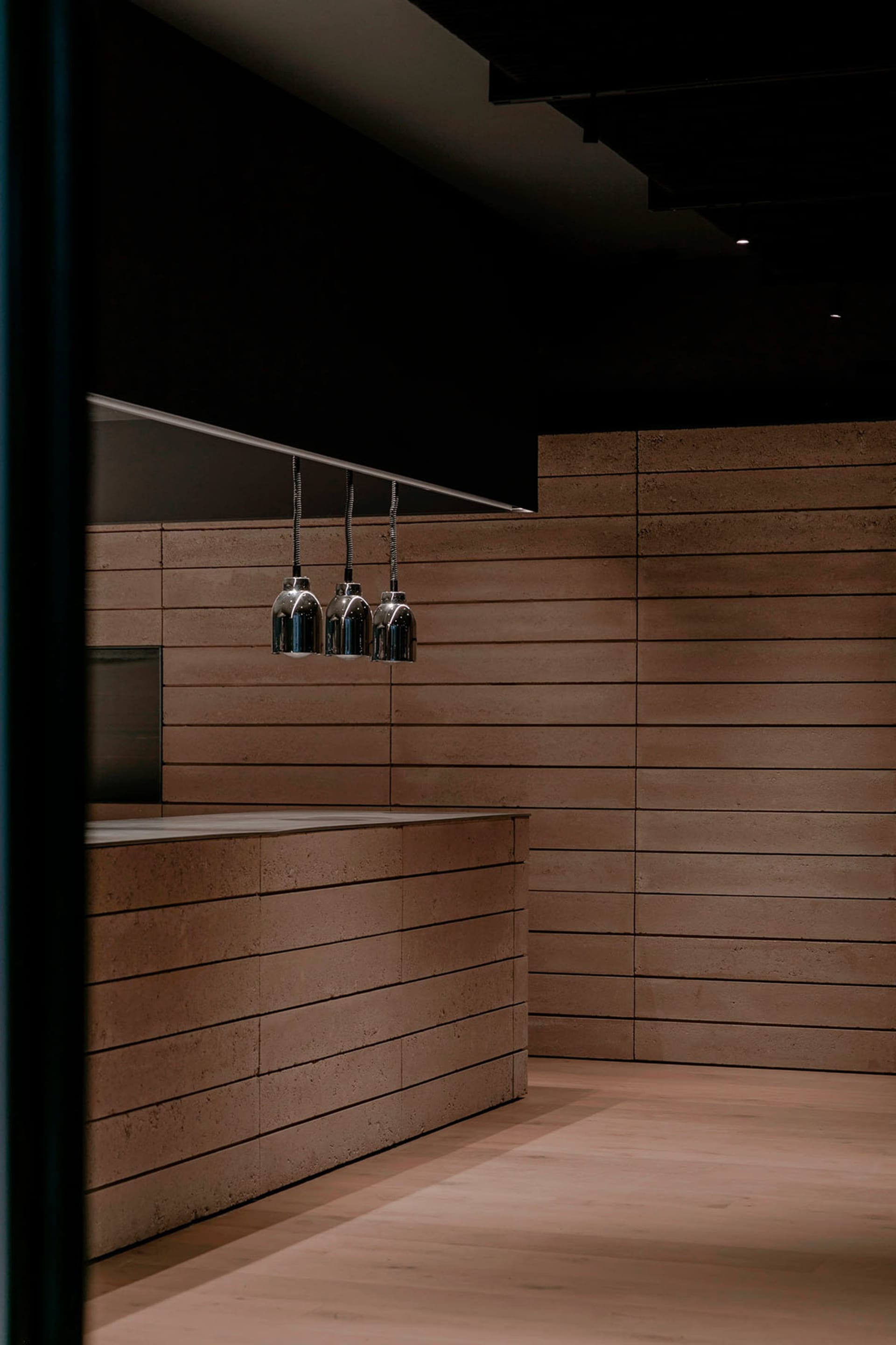 Wooden kitchen with hanging lights, warm atmosphere, and inviting space