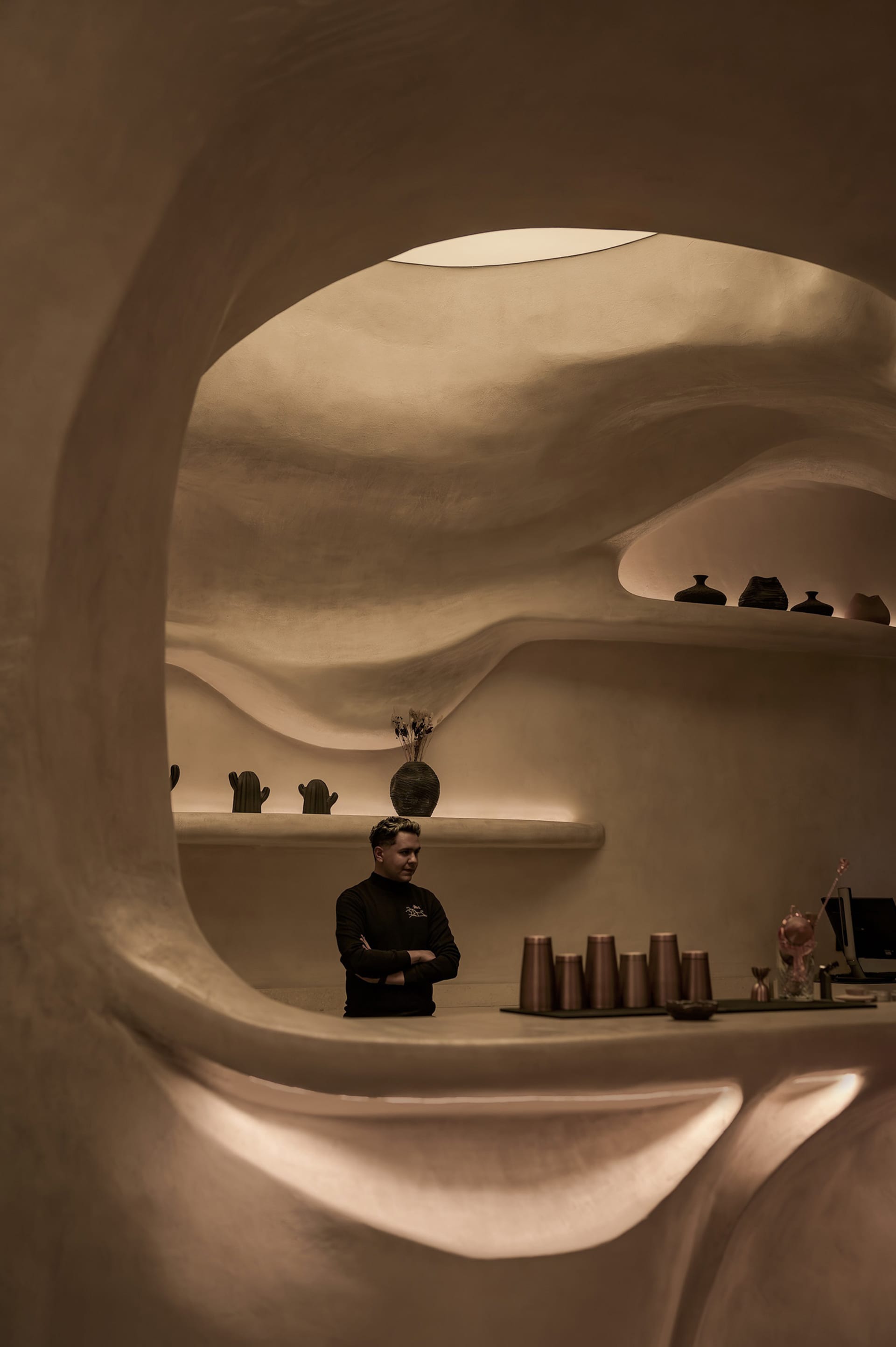Warm and inviting restaurant interior with a bar area, vases, and comfortable atmosphere