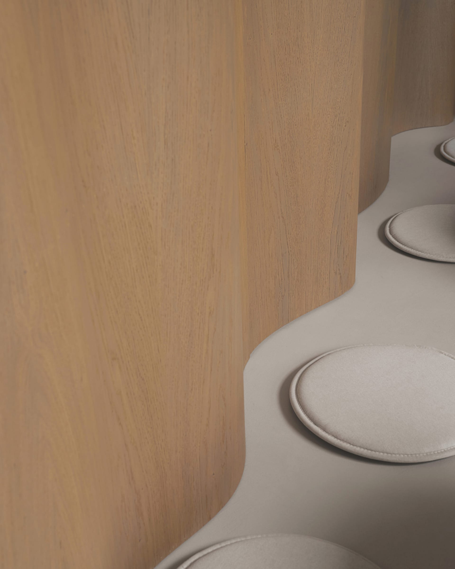 A room with a wooden wall featuring three round white objects, adding contrast and interest with a sense of simplicity and functionality