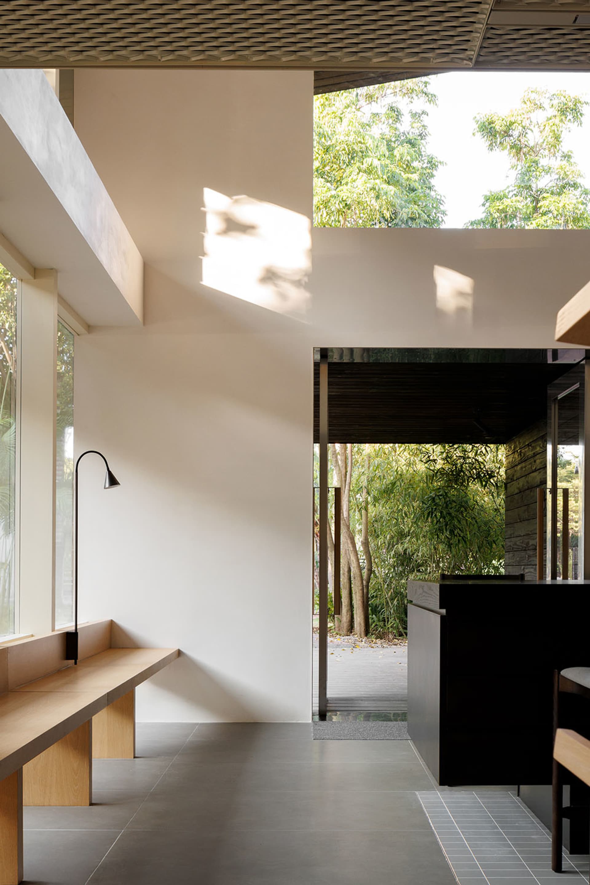 Modern kitchen with a countertop, bench seating, chairs, sink, and dining table, featuring a comfortable and inviting atmosphere