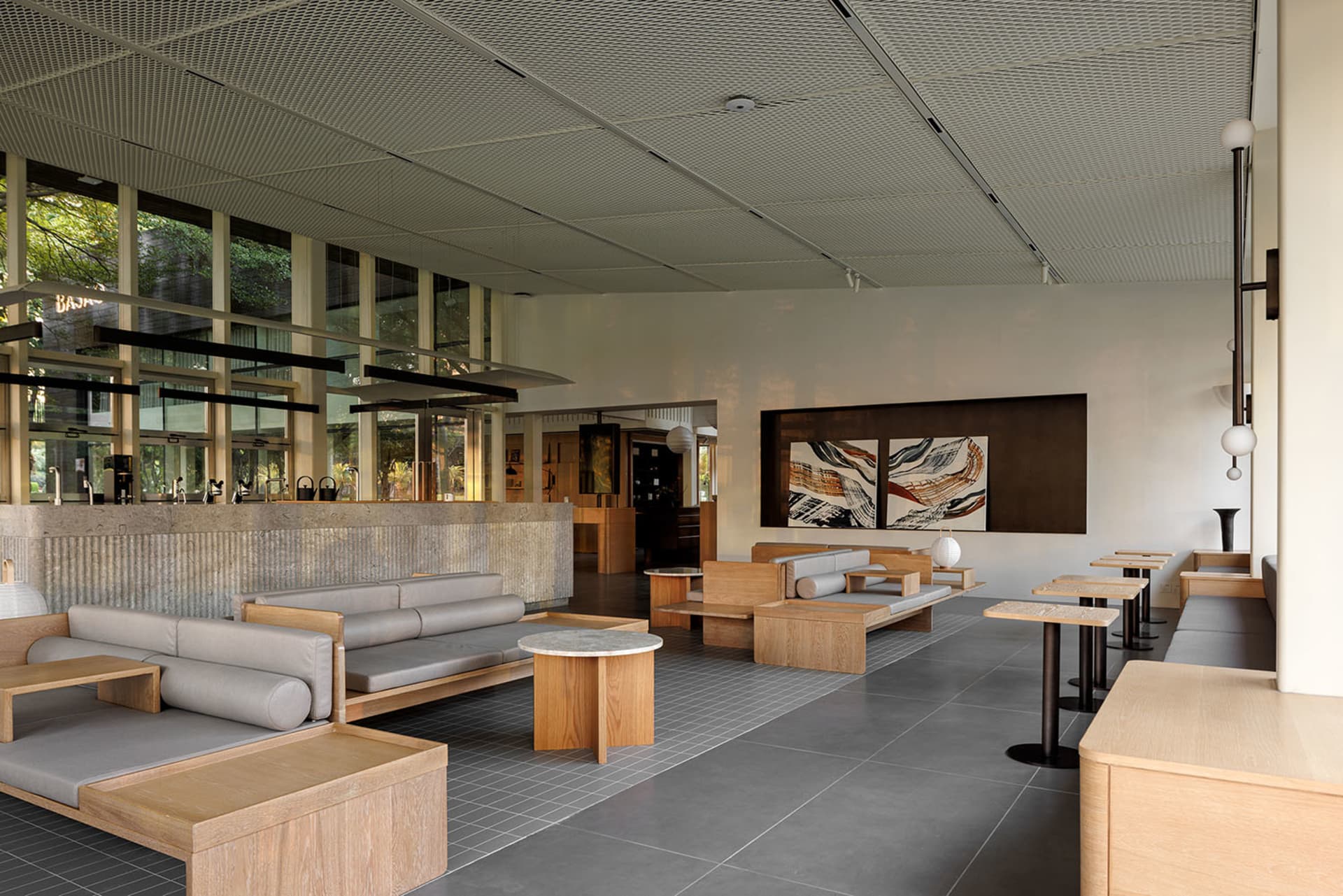 Open living area with modern furniture, neutral tones, and natural light from windows