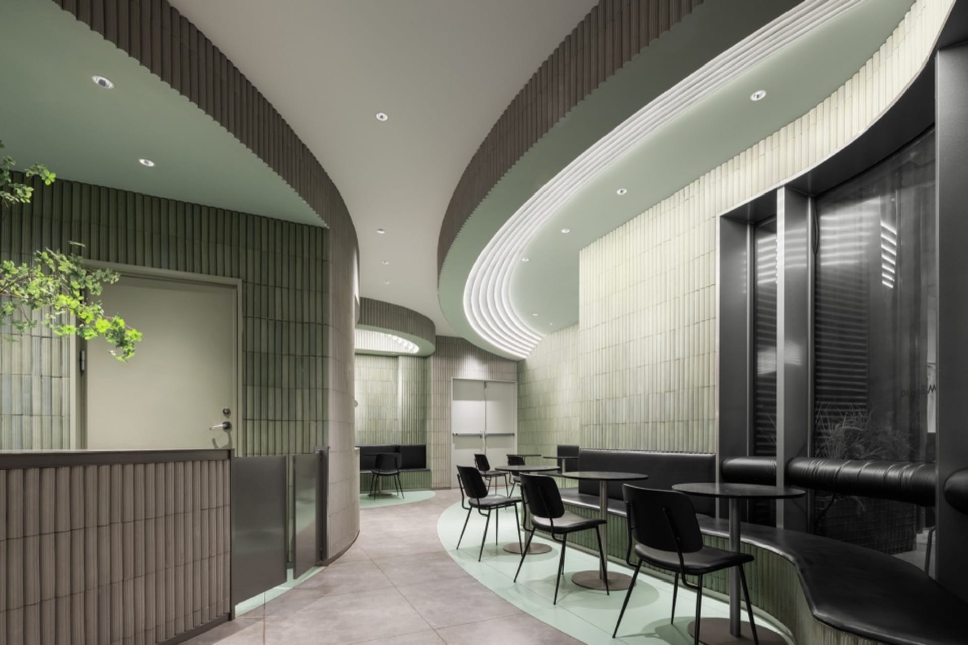 現代弧形餐廳內部，多張餐桌與座椅，營造舒適親切的氛圍