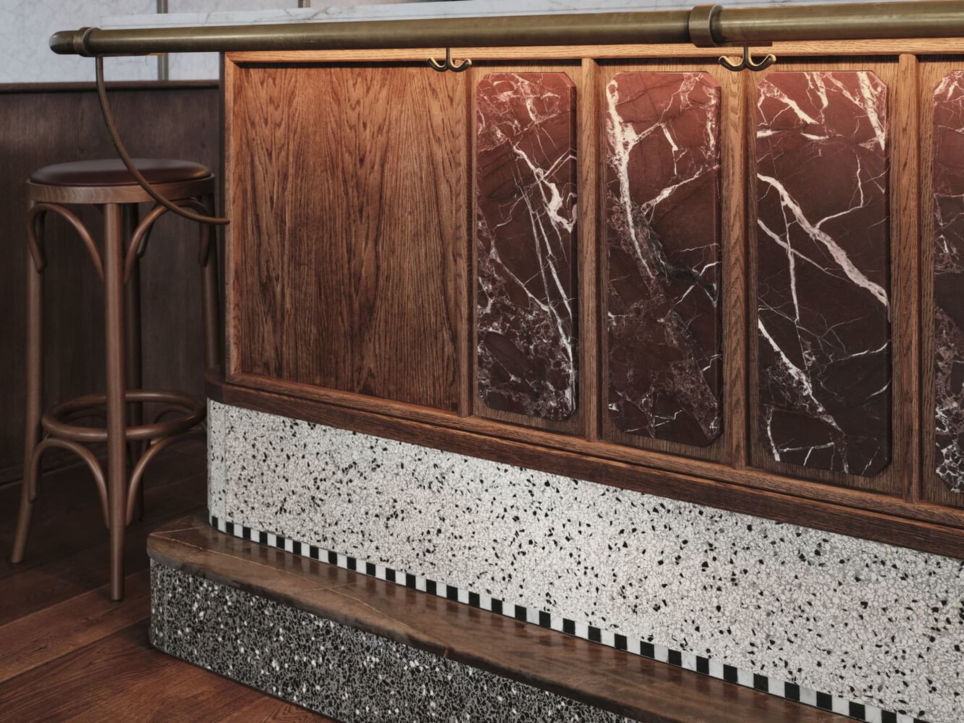 Kitchen with a wooden countertop, marble backsplash, and a chair for seating, set against a neutral background