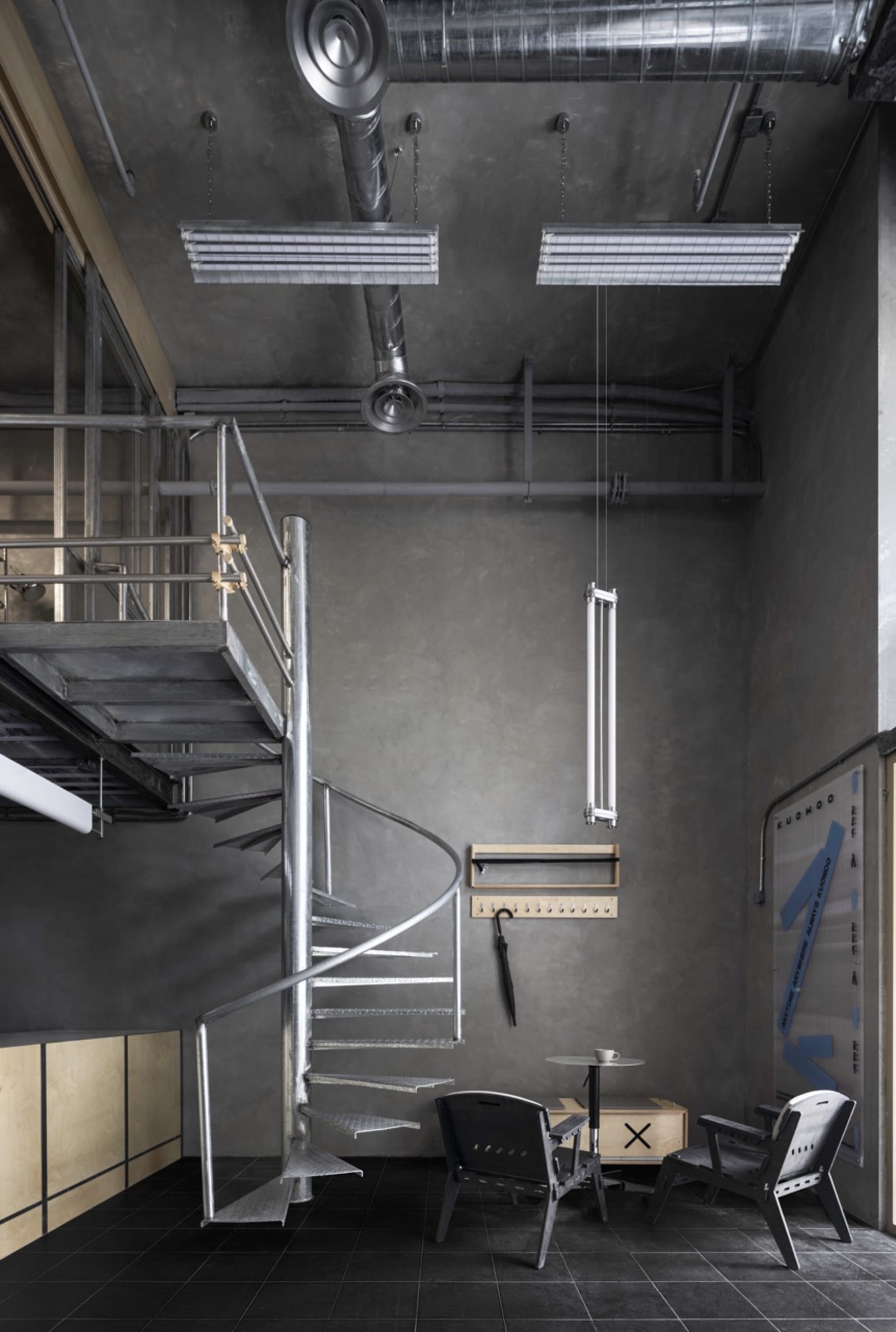 Metal spiral staircase in a functional industrial stairwell with steel stairs and a utilitarian atmosphere