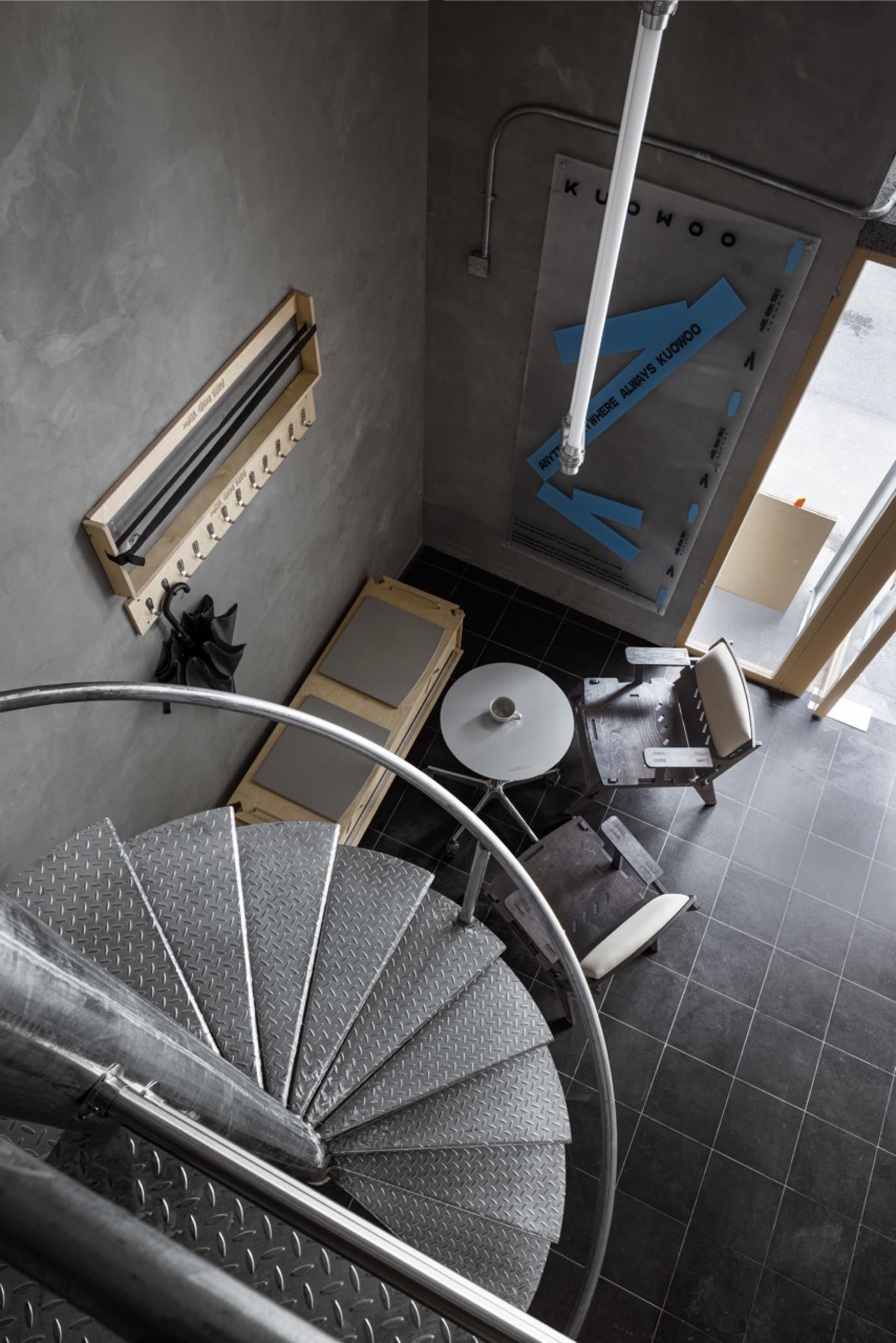 A modern staircase with a metal railing in a residential building, well-lit with possible natural and artificial light sources