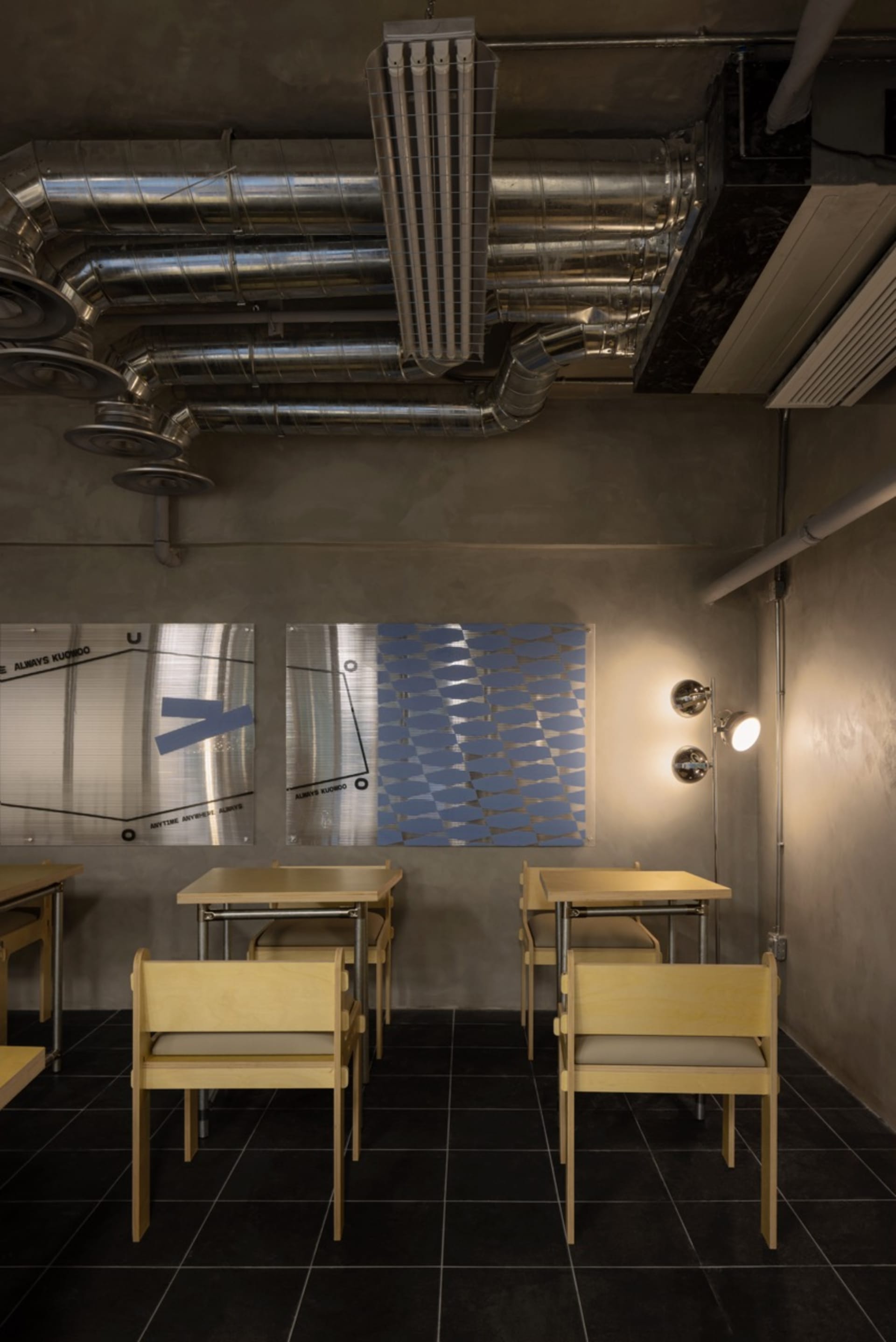 A modern classroom with wooden chairs and tables, arranged in rows for comfortable seating and ample surface space for studying and projects