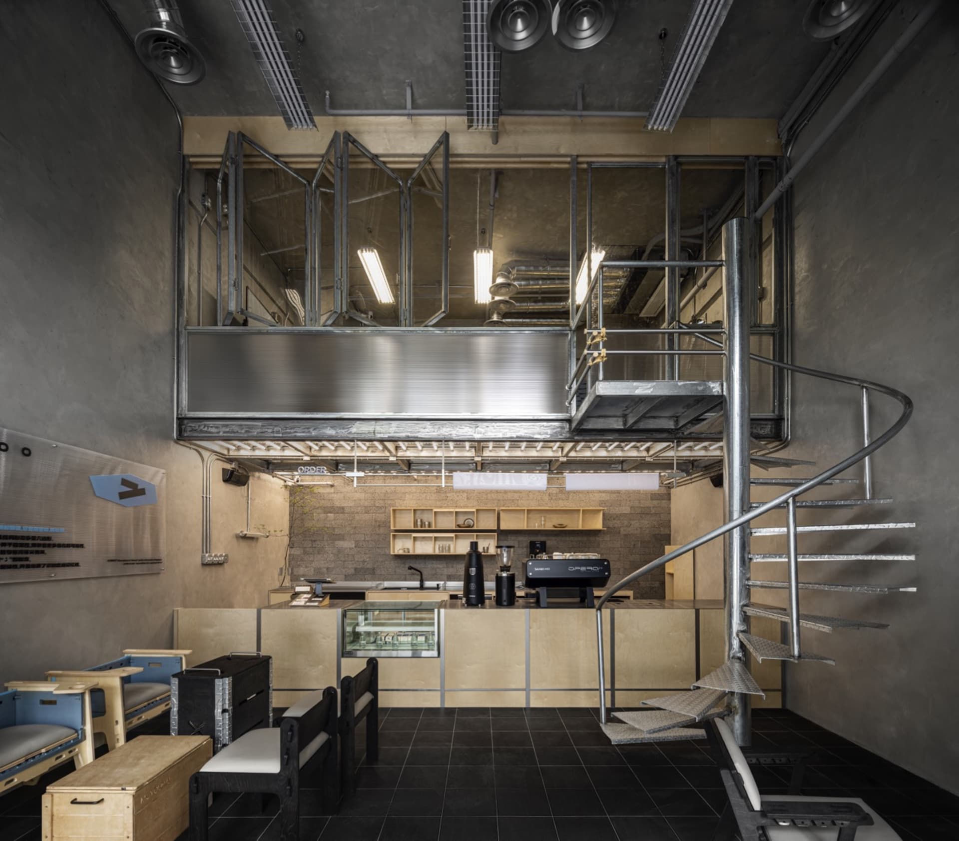 Modern kitchen and dining area with a staircase, appliances, chairs, and ample space for cooking and socializing