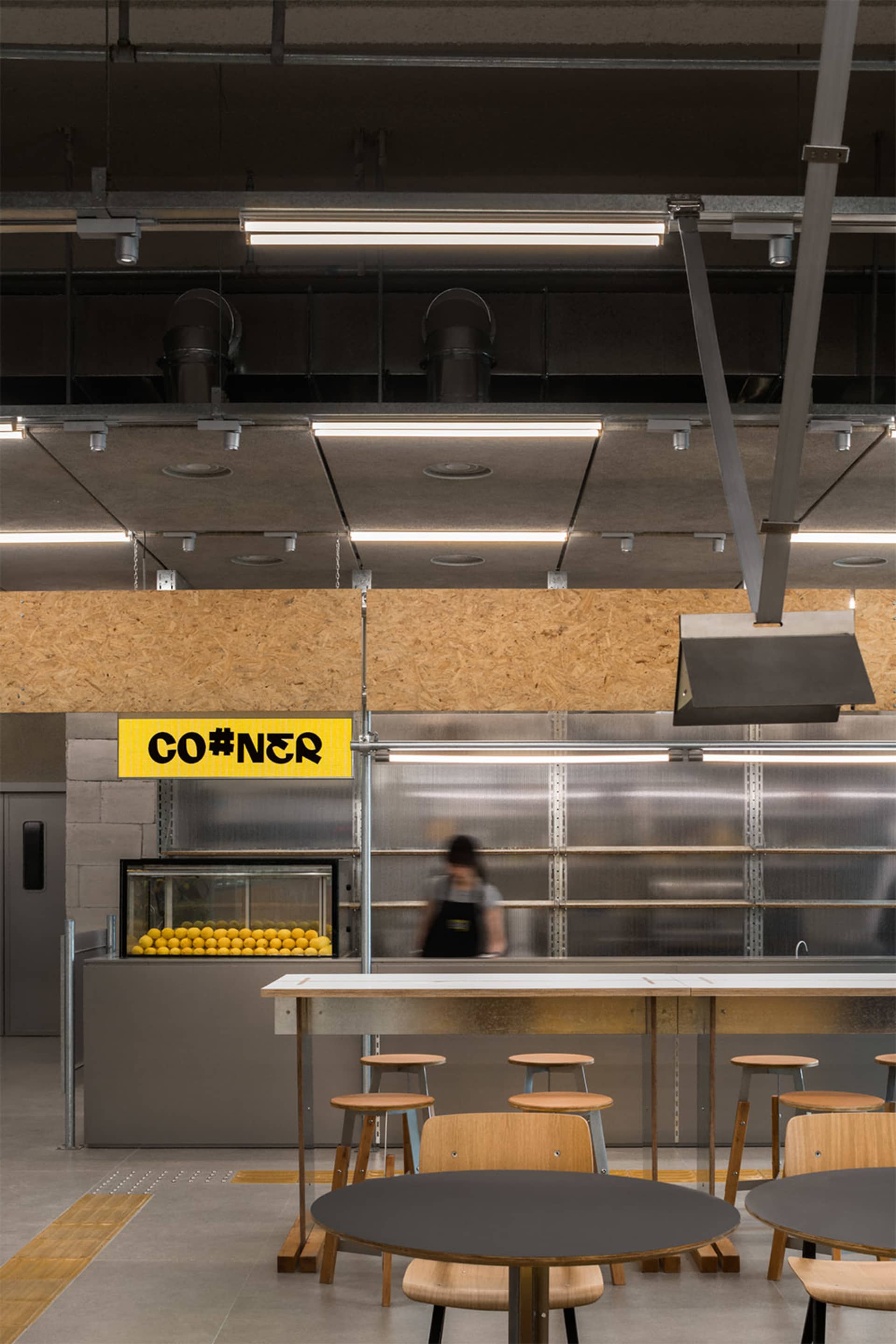 Inviting restaurant kitchen with a counter and chairs, bottles, and a focus on functionality and convenience