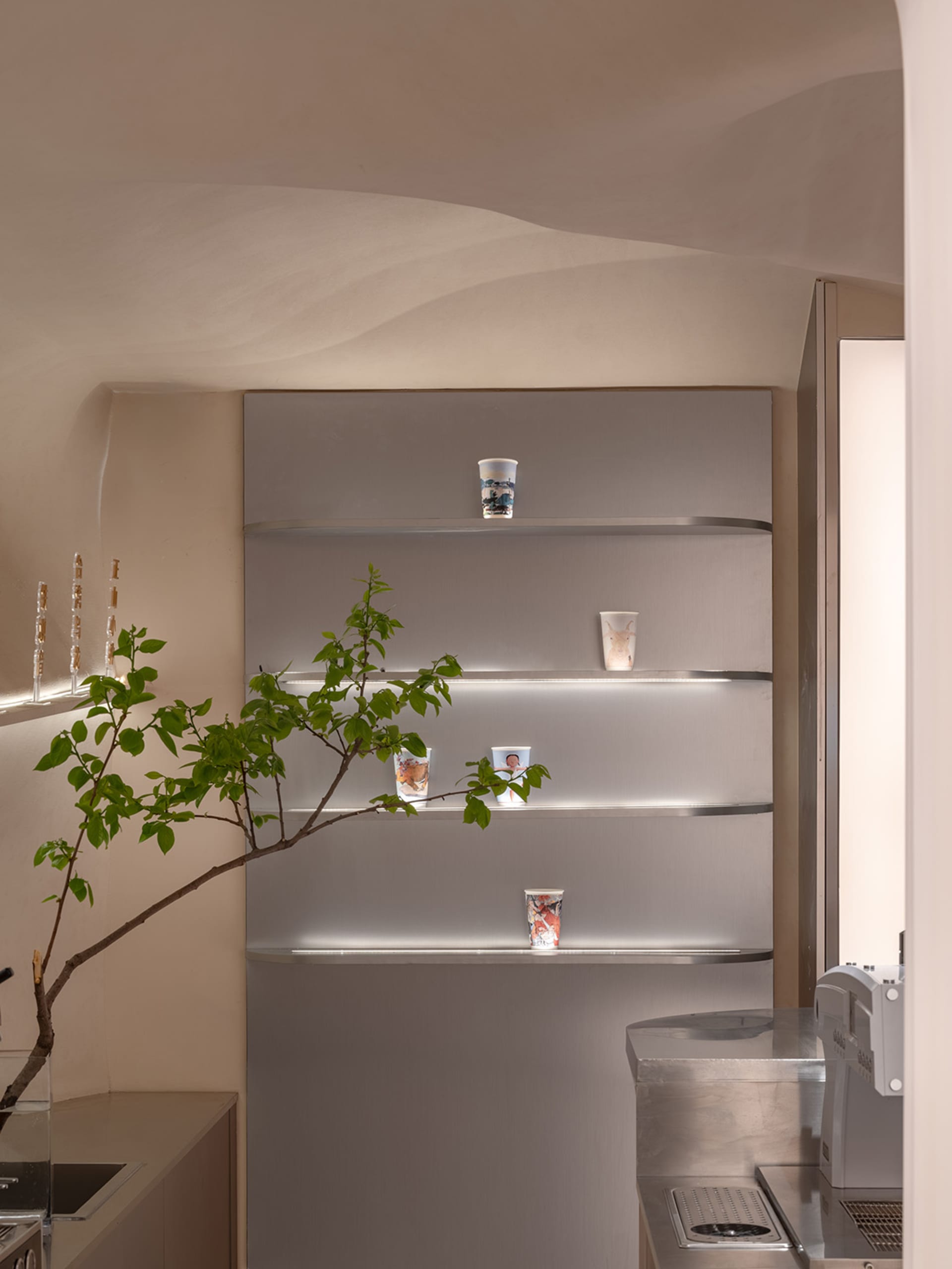 Clean and organized bathroom with a toilet and sink, featuring shelves and bottles