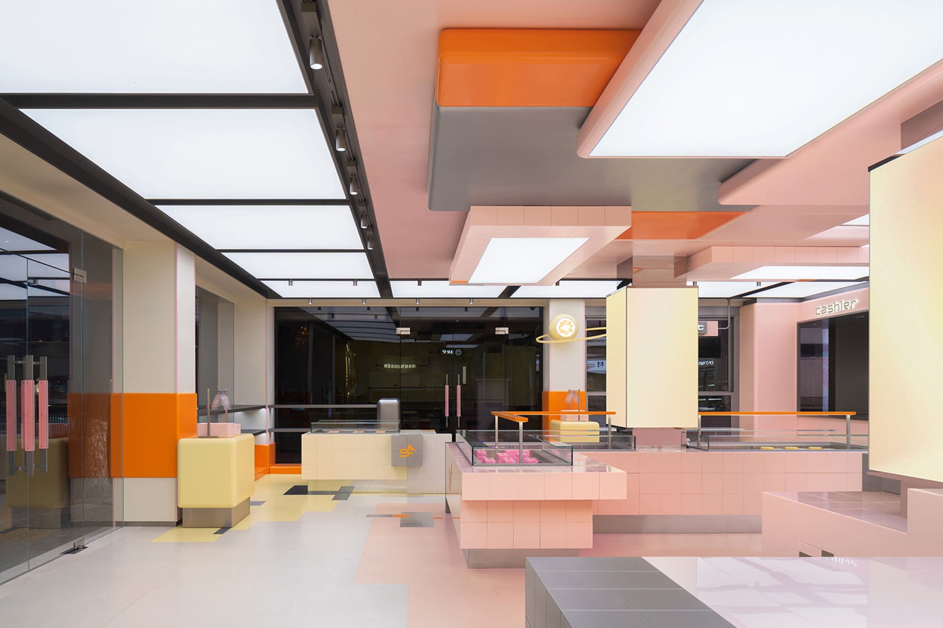 A restaurant interior with pink and orange accents, decorative elements, and comfortable seating for guests