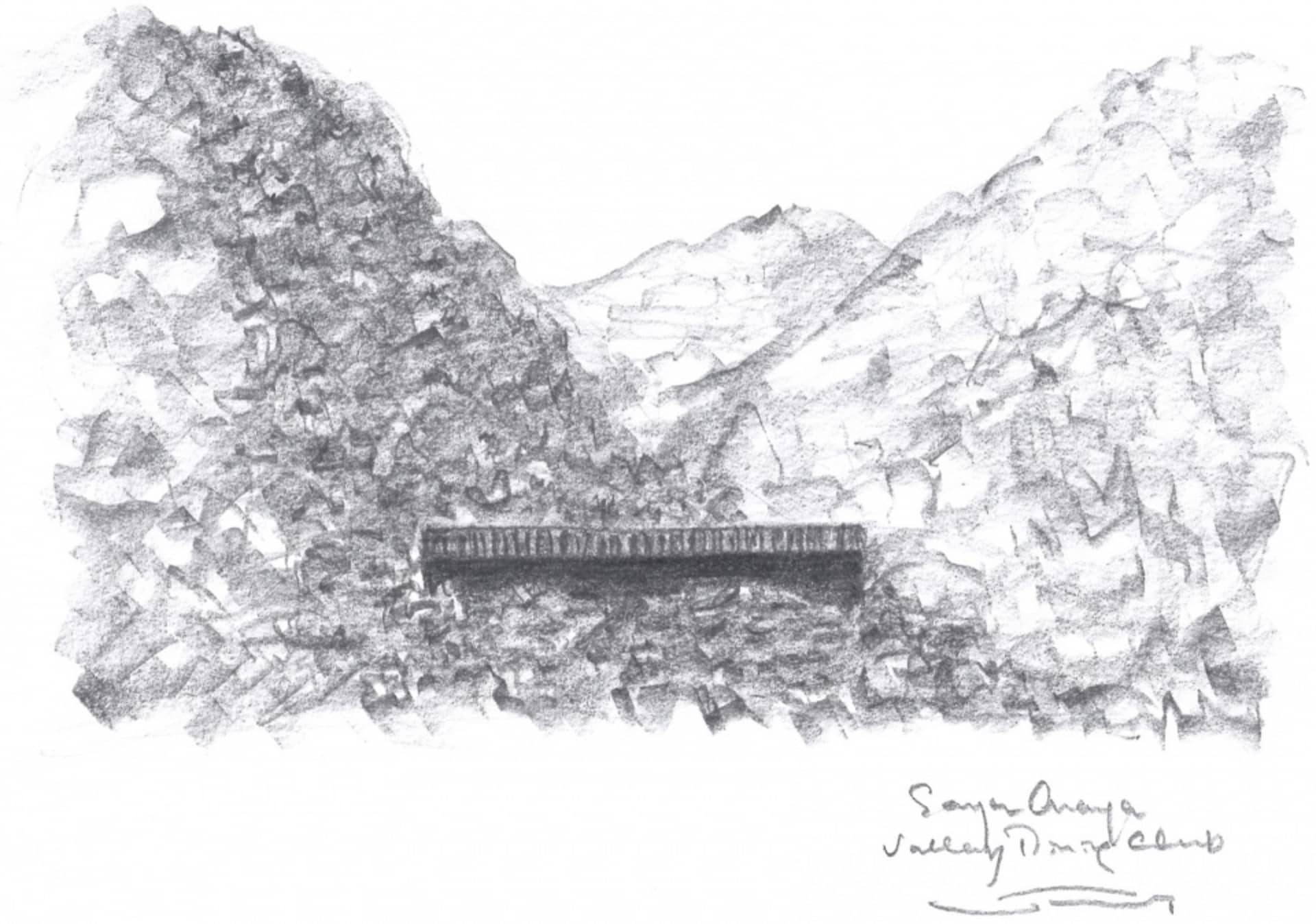 A black and white photo of a stone bridge spanning a valley with mountains in the background