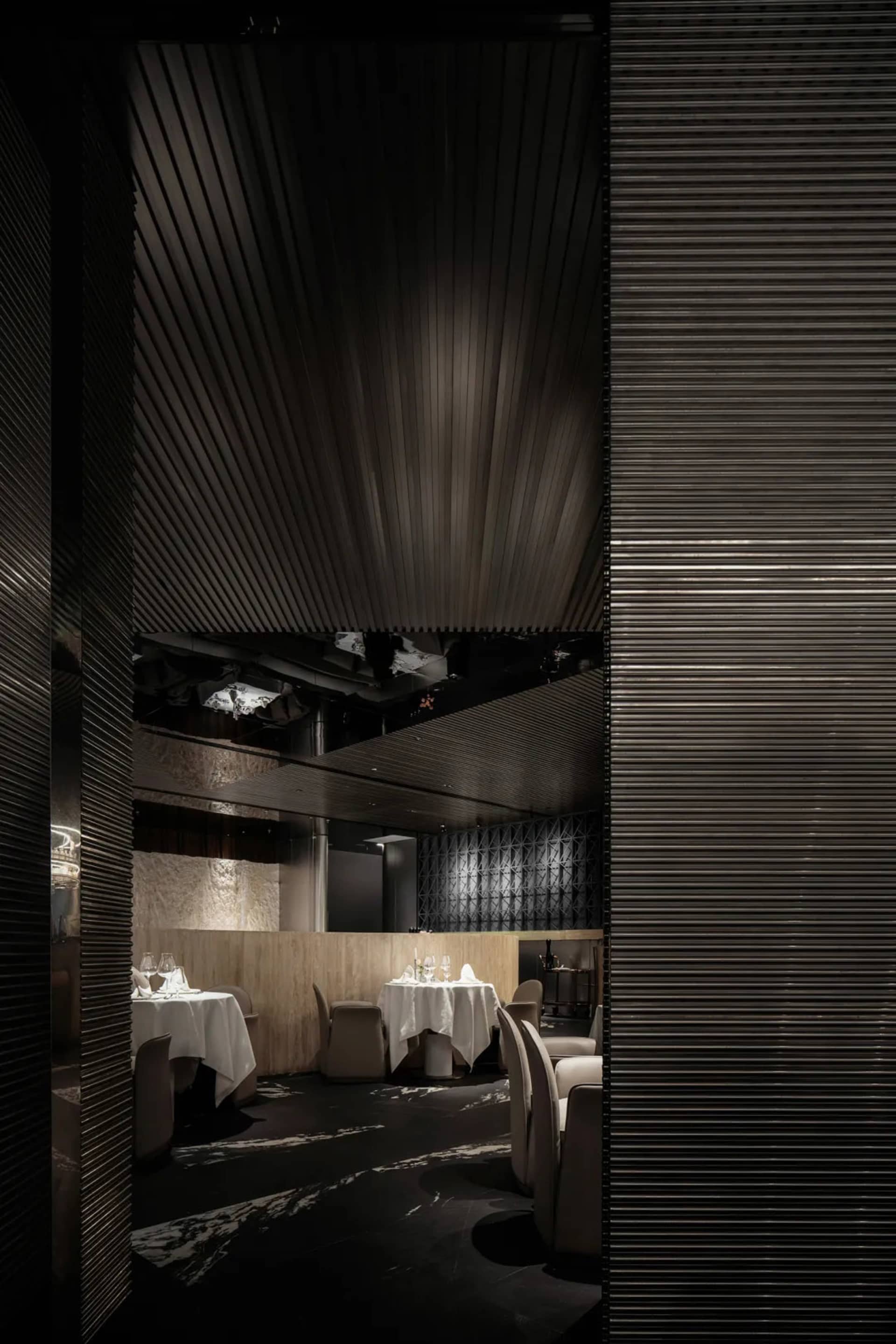 Empty restaurant dining area with wooden tables, wine glasses, and a calm atmosphere