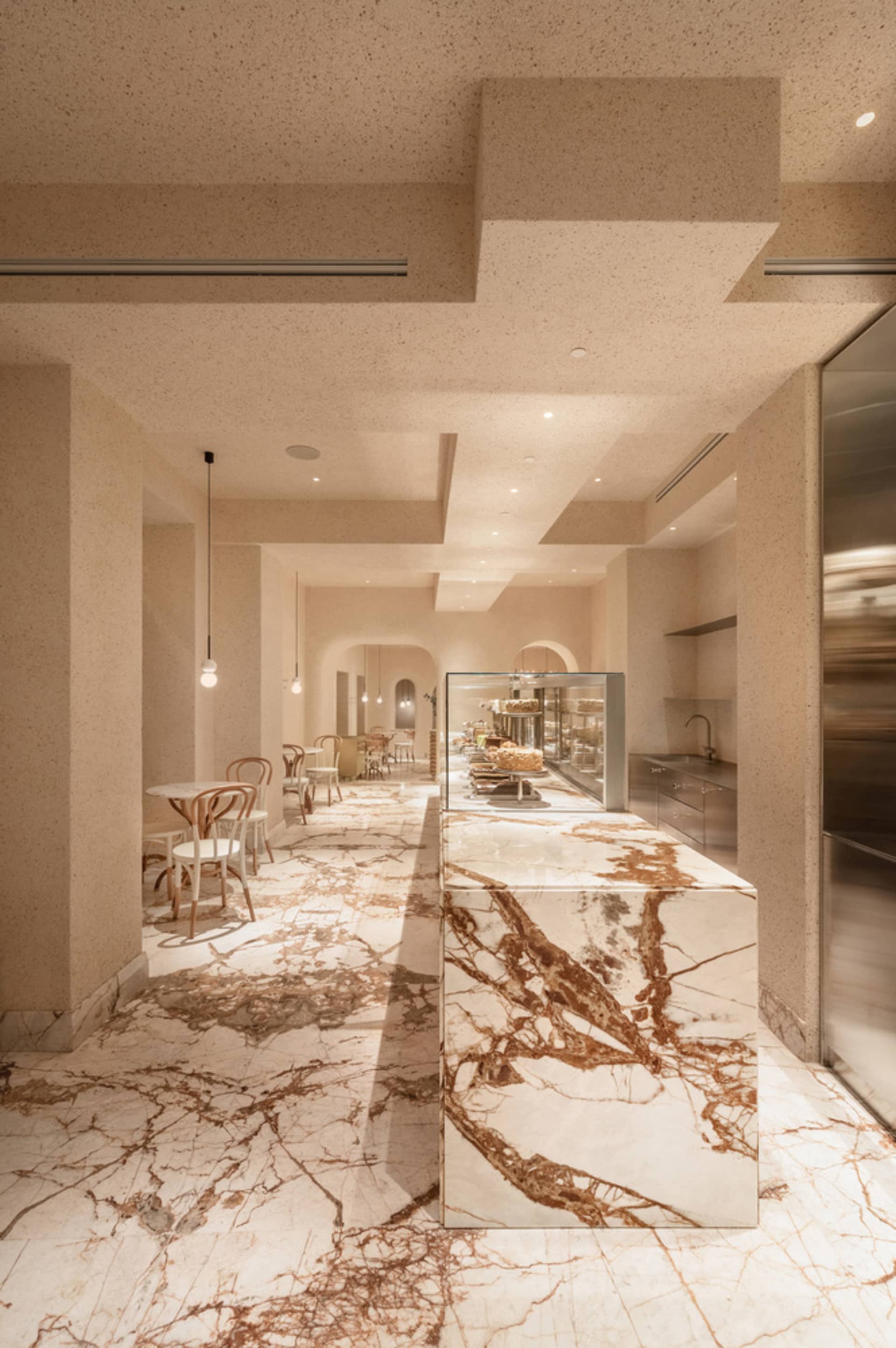 Modern kitchen with a marble island, comfortable seating, and upscale design elements