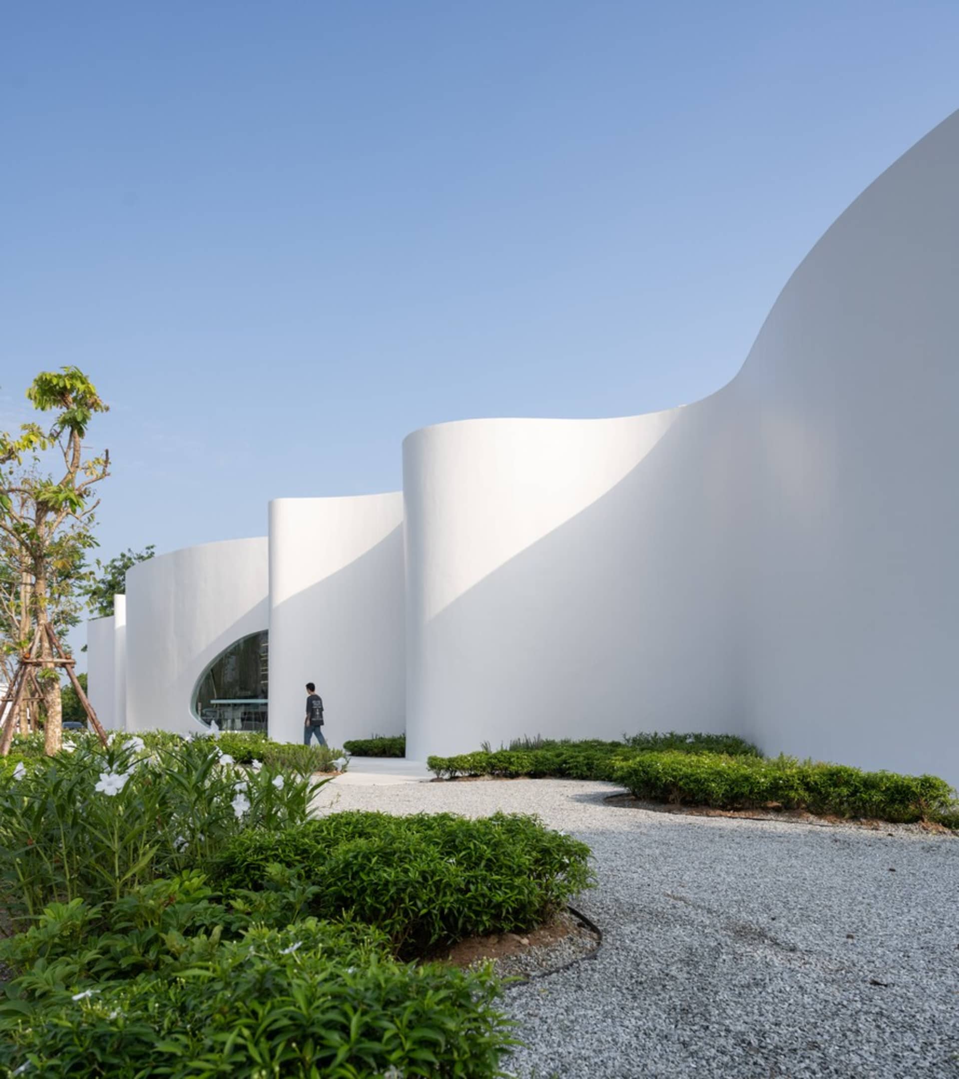 一座大型白色建築，擁有曲線牆面與圓形入口，營造寧靜而吸引人的氛圍