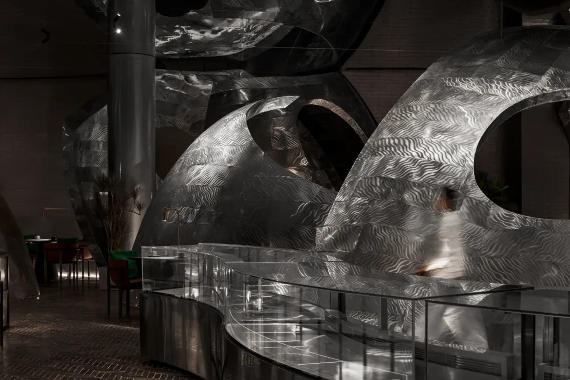A futuristic interior space with a large dome structure featuring unique metal designs and a modern atmosphere