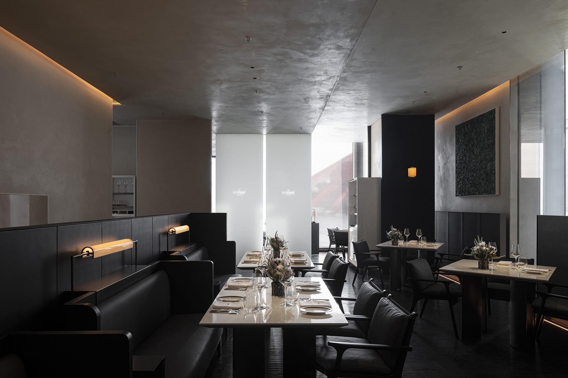 Elegant restaurant interior with dining area, tables, chairs, and wine glasses, set in a comfortable and inviting atmosphere