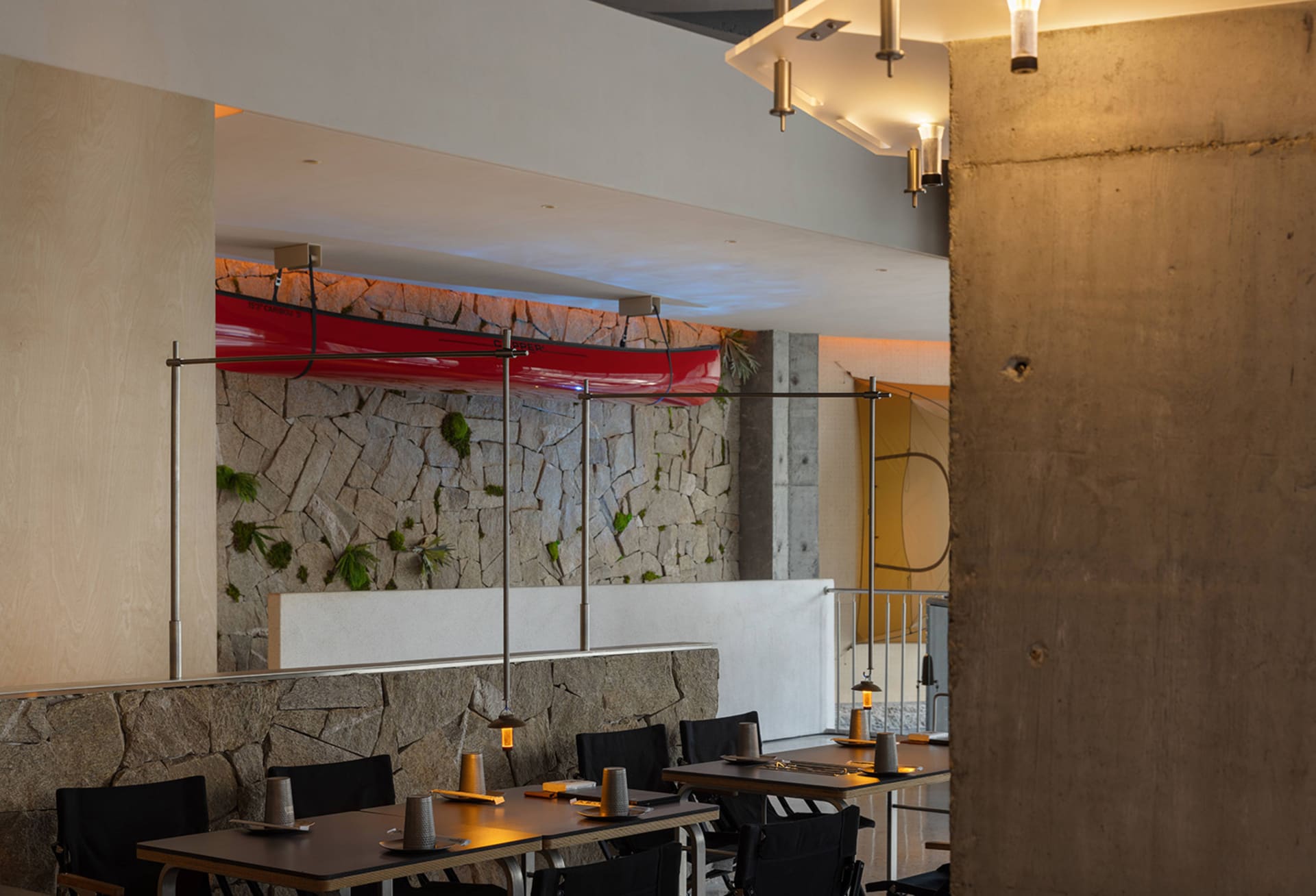 A modern restaurant interior with tables and chairs, cups on some tables, and a welcoming atmosphere