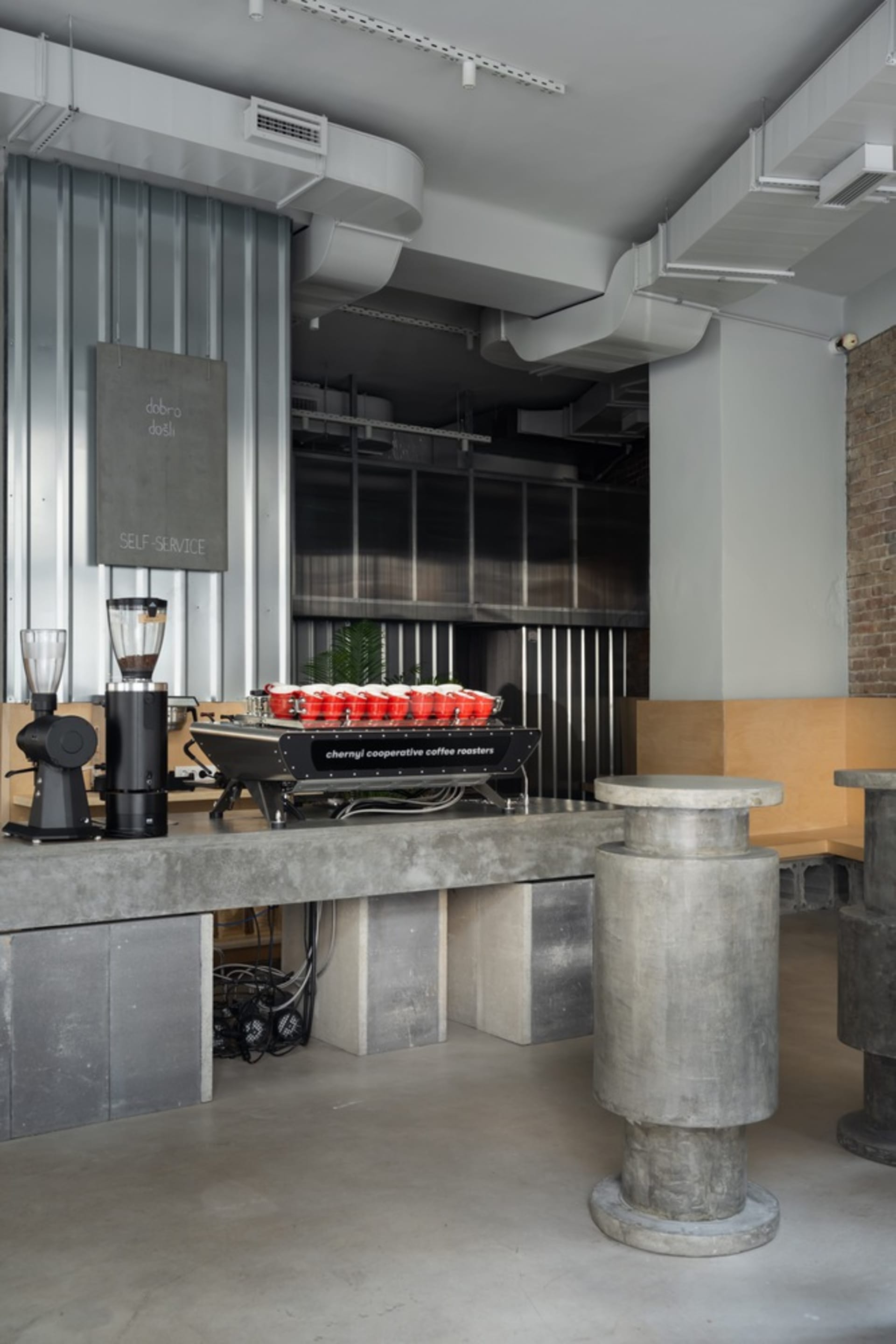 Modern kitchen with a countertop featuring appliances and multiple cups, ample workspace, and storage options