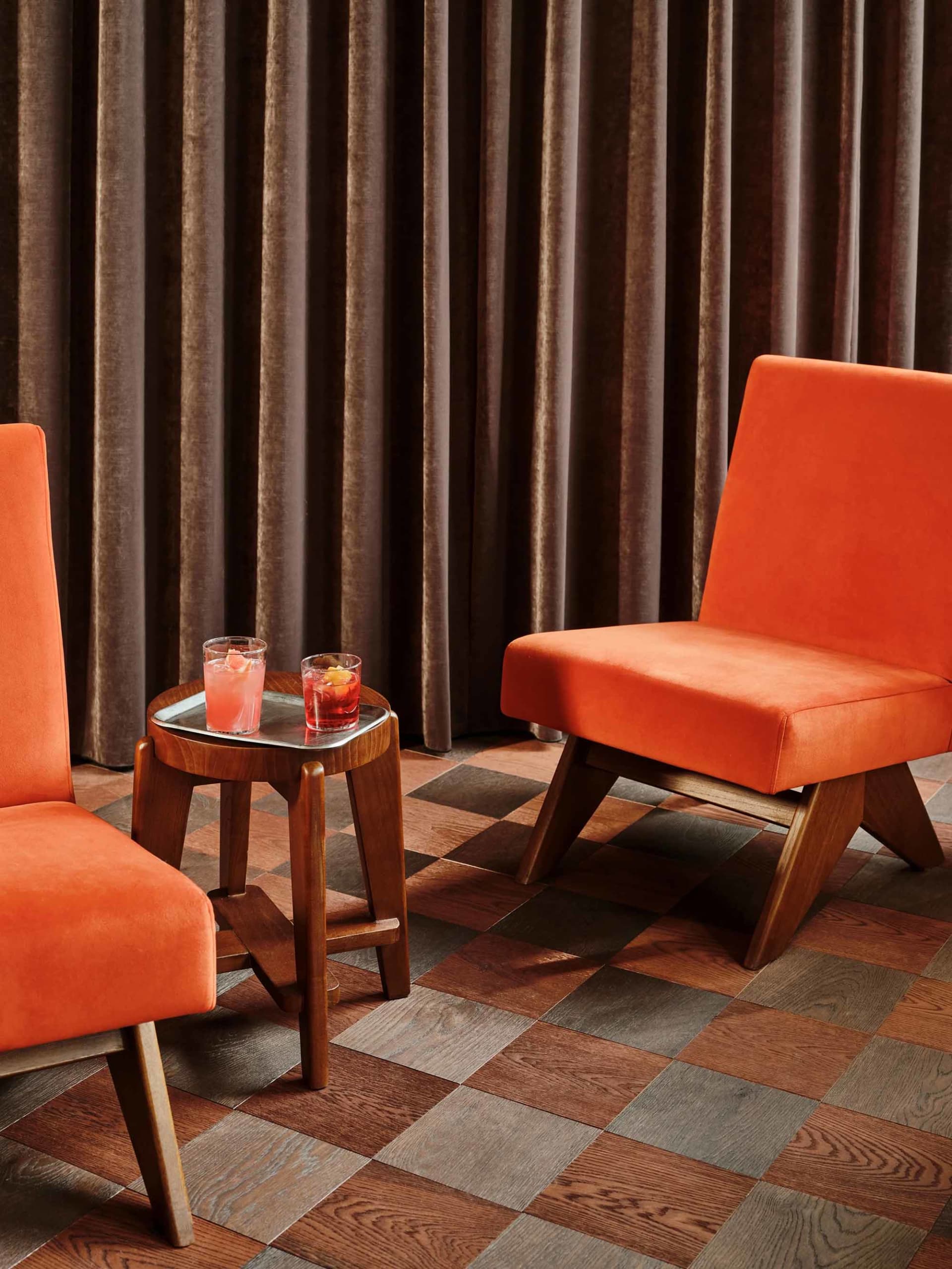 A cozy living area with a fabric chair and wooden table, set up for conversation or relaxation