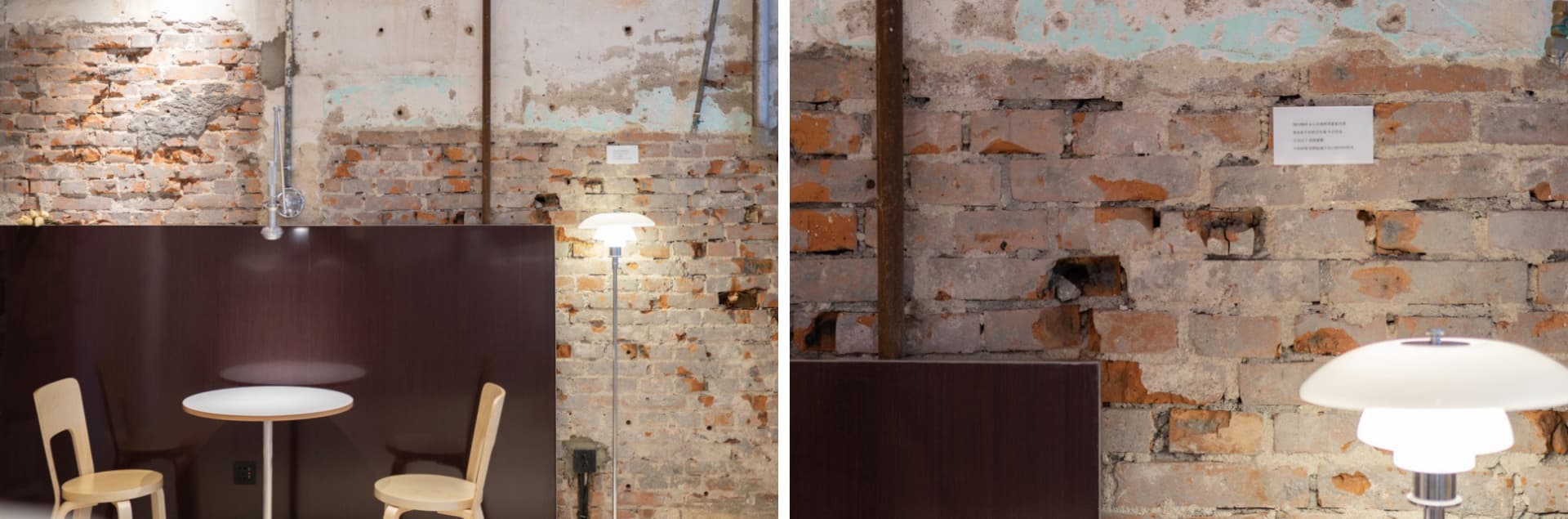 Exterior view of an old brick building with a lamp and a wooden desk in front of a brick wall