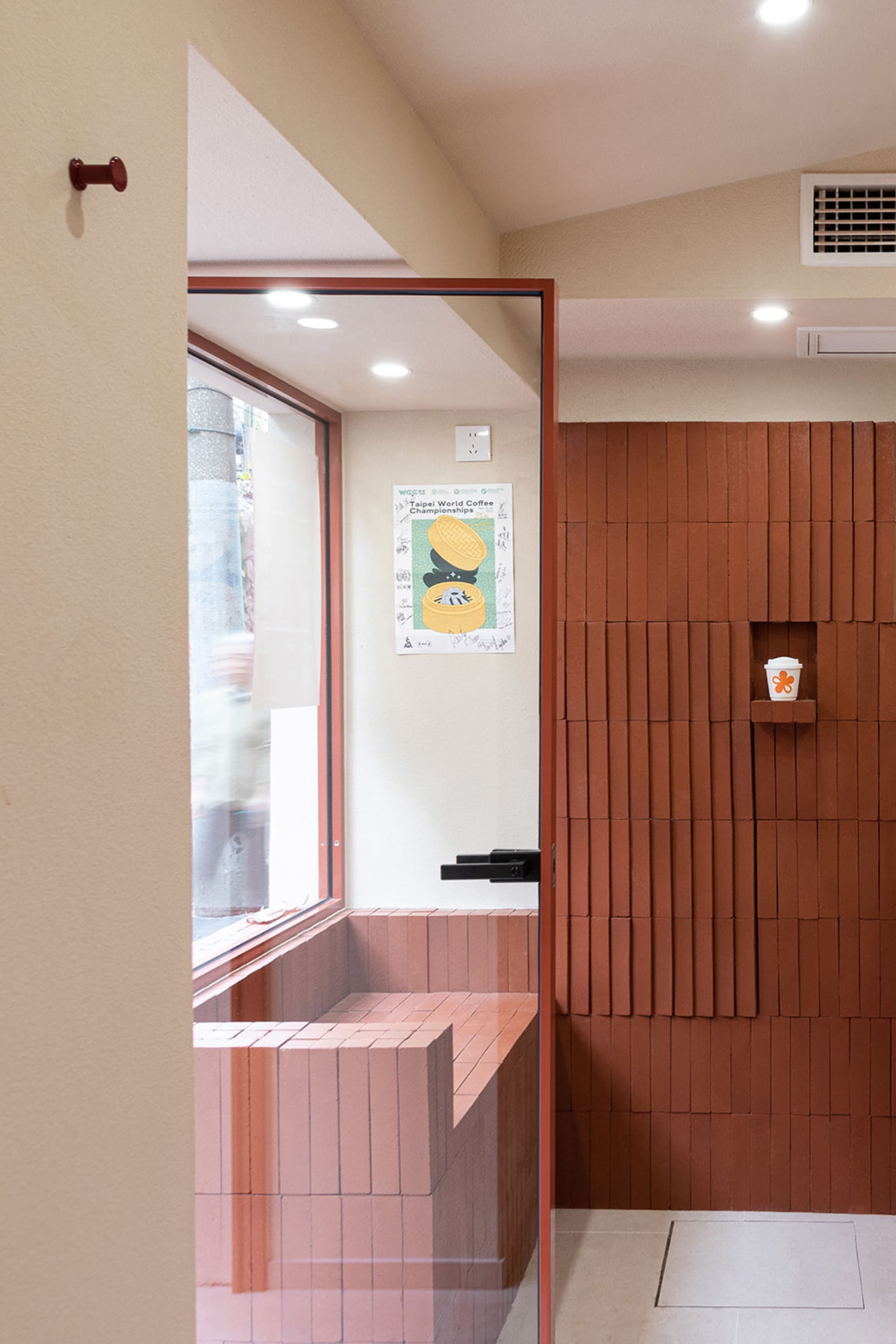 Cozy bathroom with a brick wall, a wooden bench, and two people in the scene