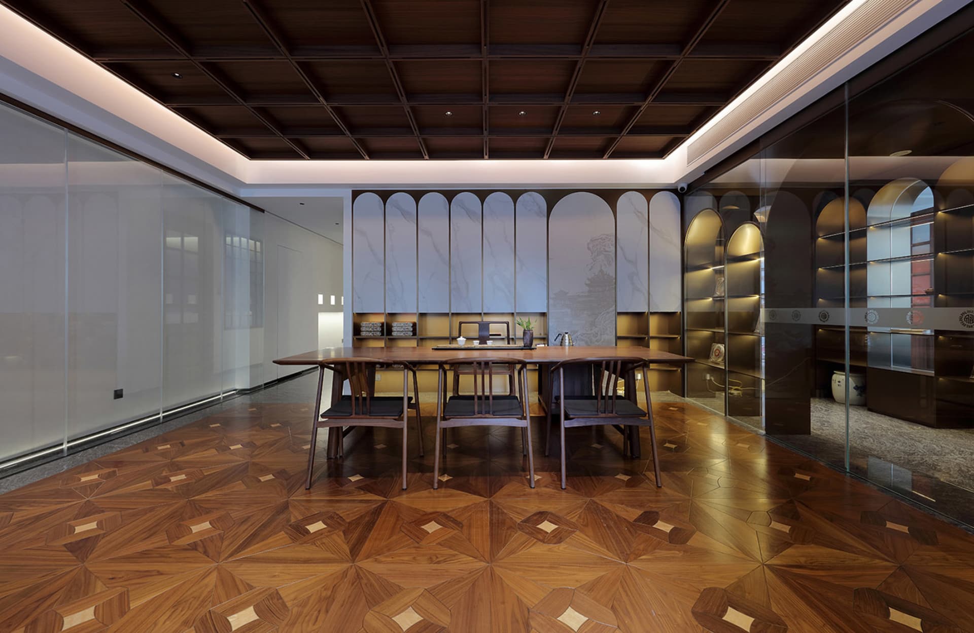 Elegant dining space with a large wooden table, marble top, and several chairs, set in a well-lit room with a modern yet classic design