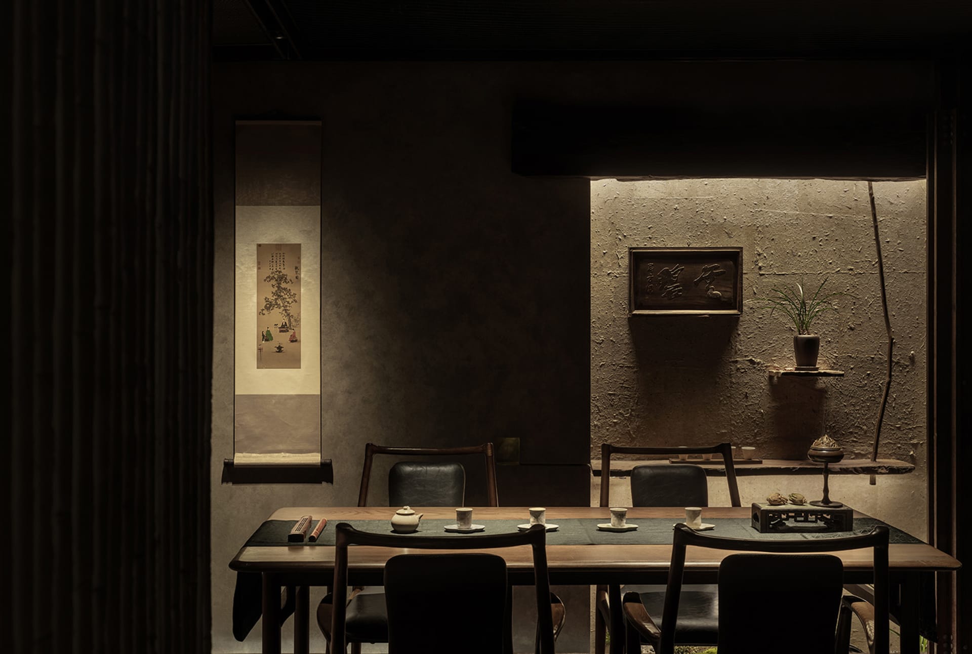Cozy Asian restaurant interior with a dining table, wooden chairs, and a potted plant, surrounded by traditional Chinese decor