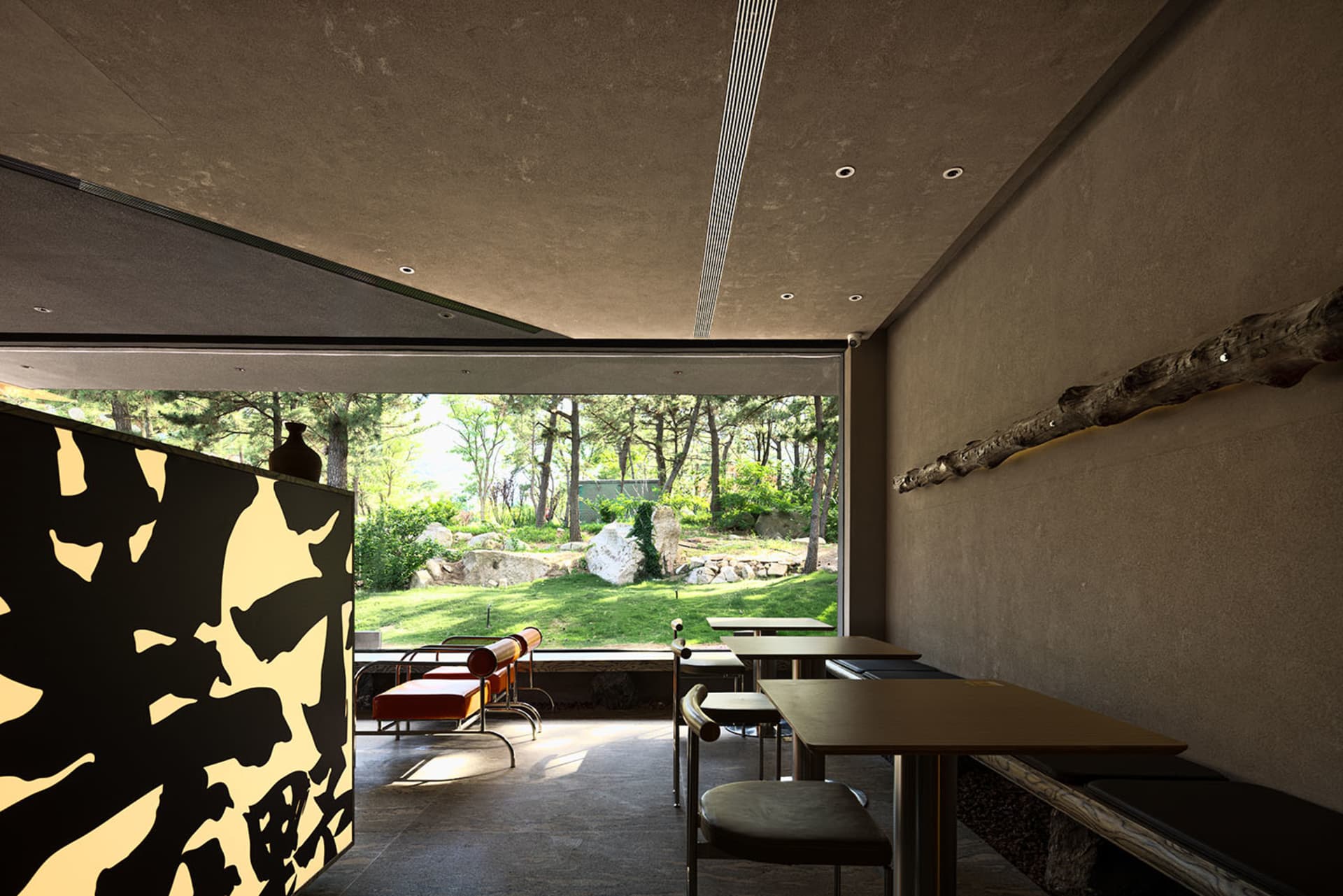 Modern restaurant interior with a dining area, bar counter, and comfortable seating for guests