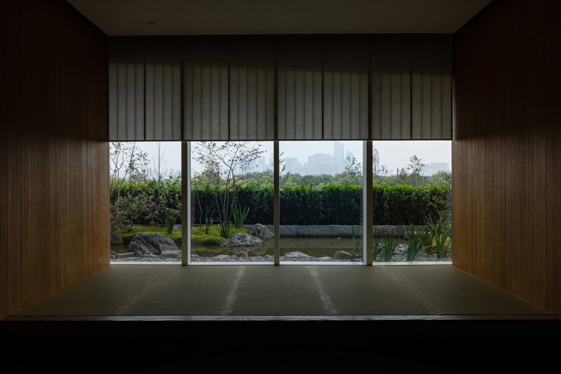 A large building with a mix of modern and contemporary design elements, featuring large windows and a well-lit interior with a sense of openness and spaciousness