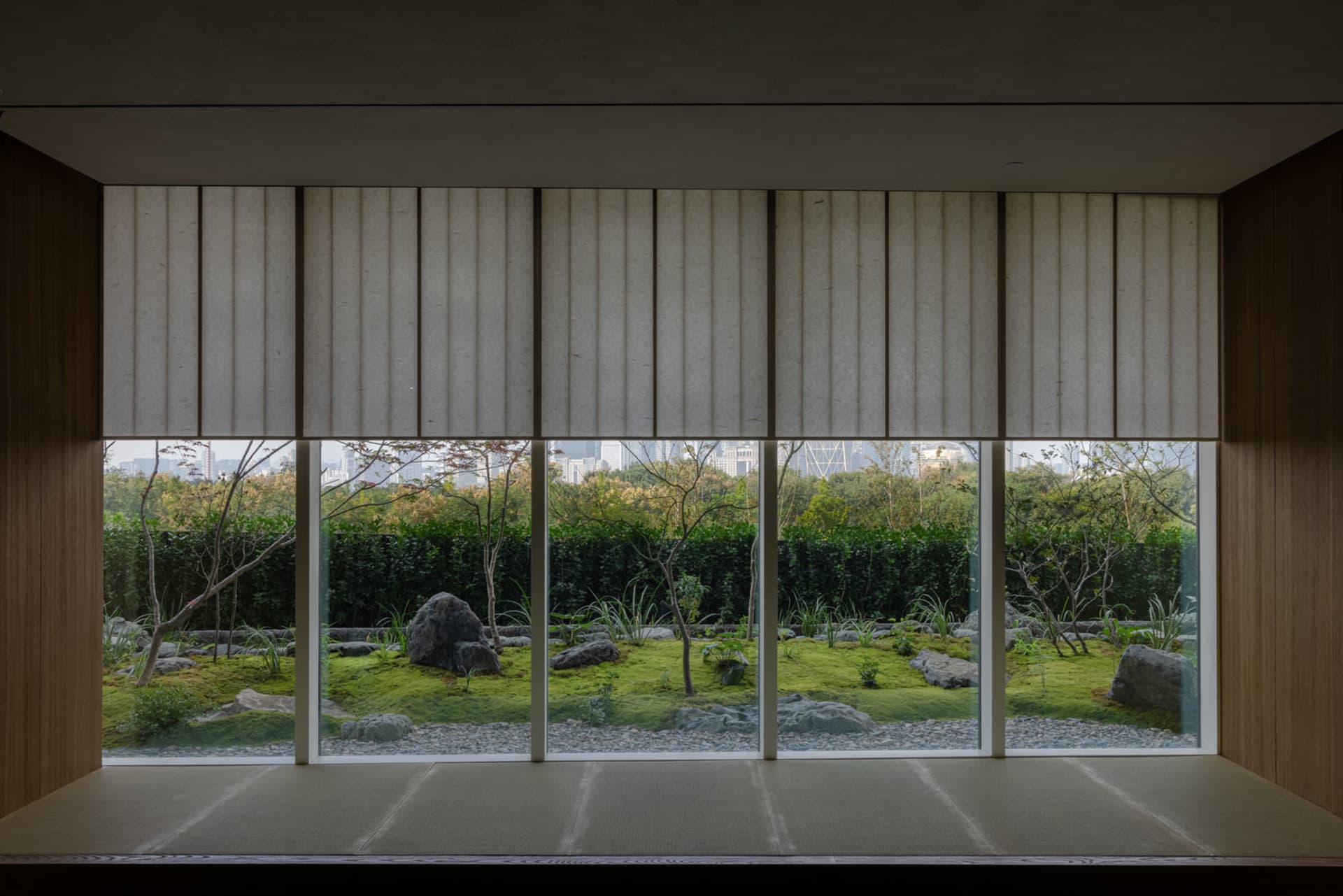 Modern office building with large windows, white curtains, and a combination of concrete and glass exterior elements
