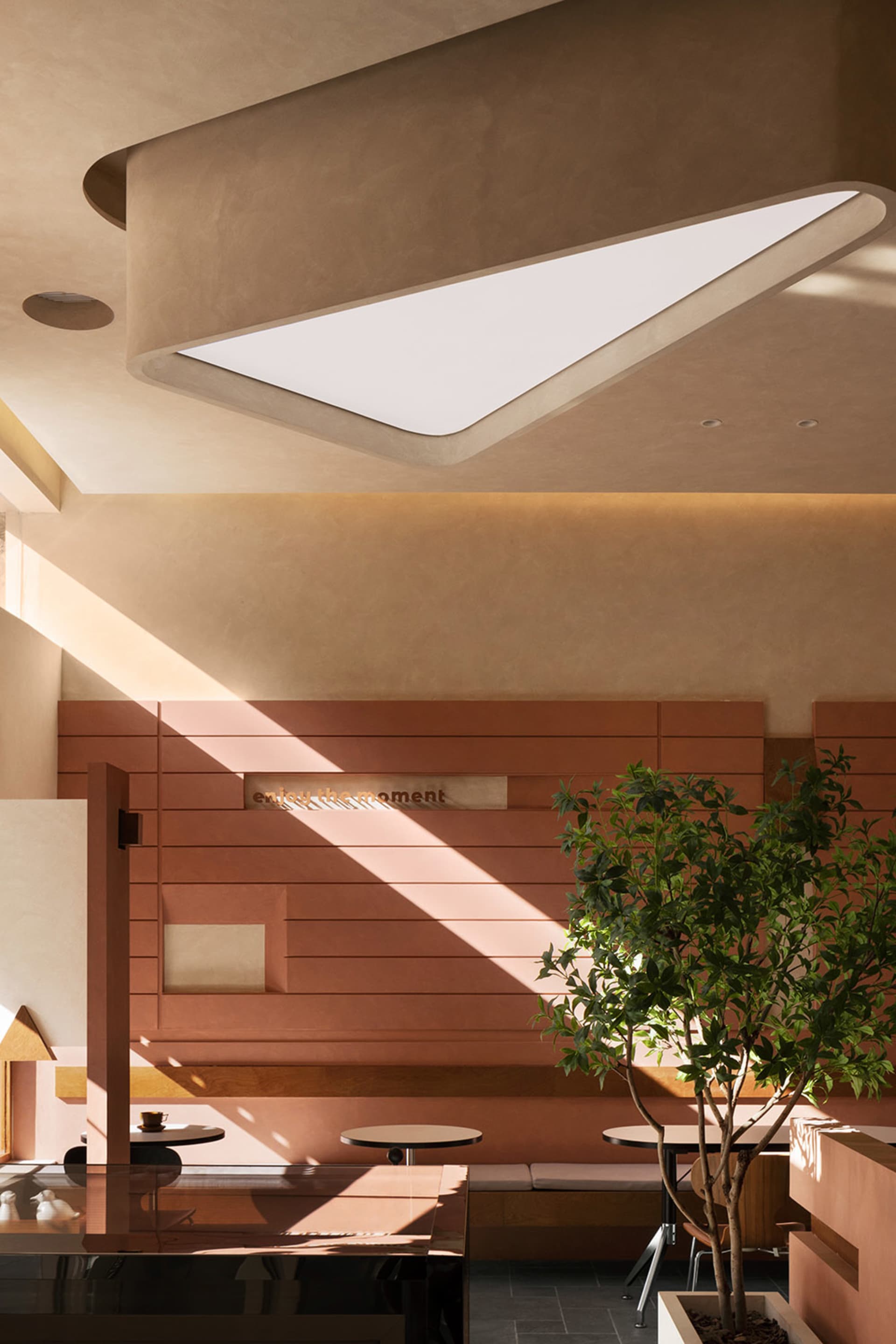 A hotel lobby with wooden walls and ceilings, featuring two potted plants and a clock on the wall, creating a warm and inviting atmosphere