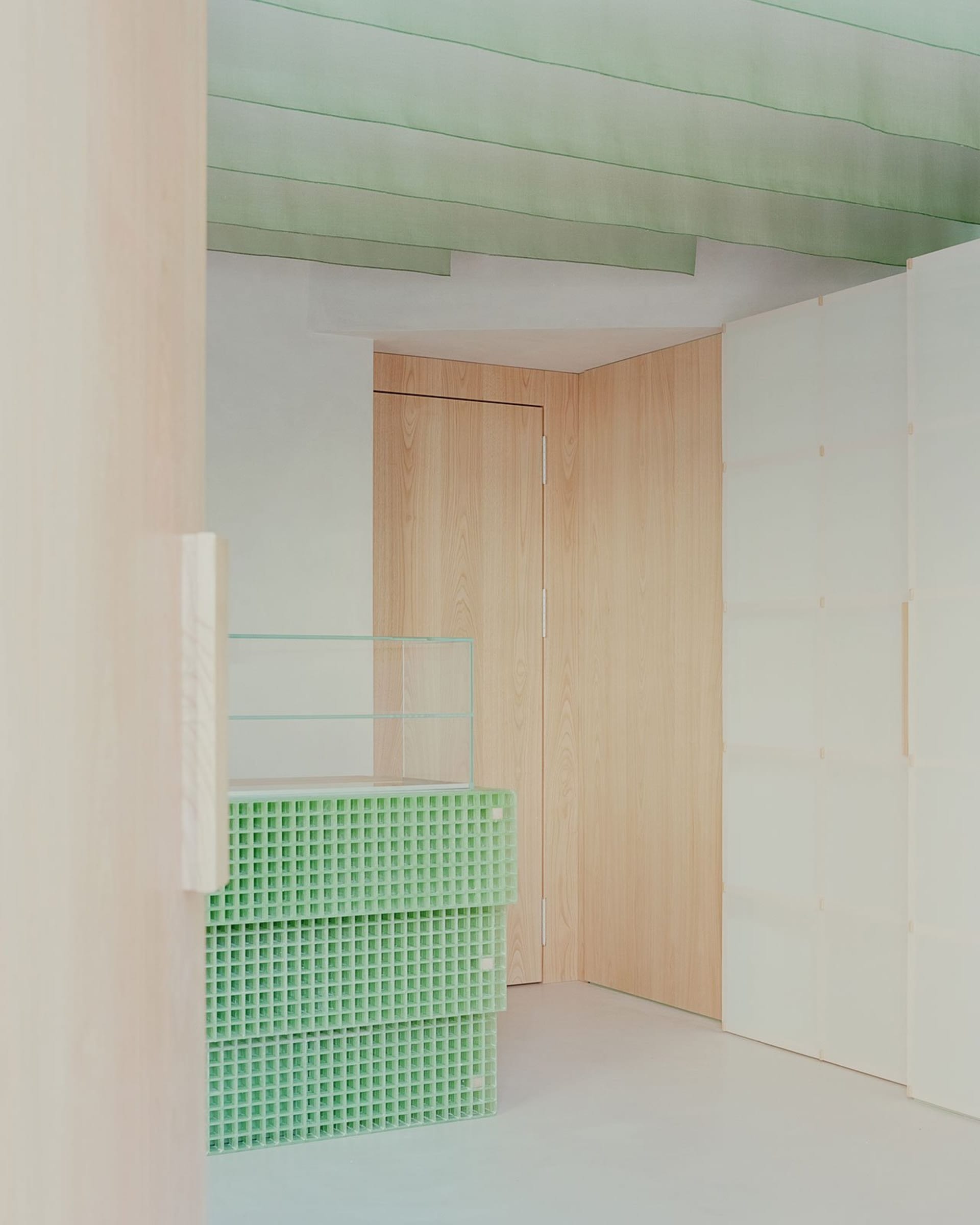 A calm and peaceful hallway made of wood with an open doorway leading to a hallway