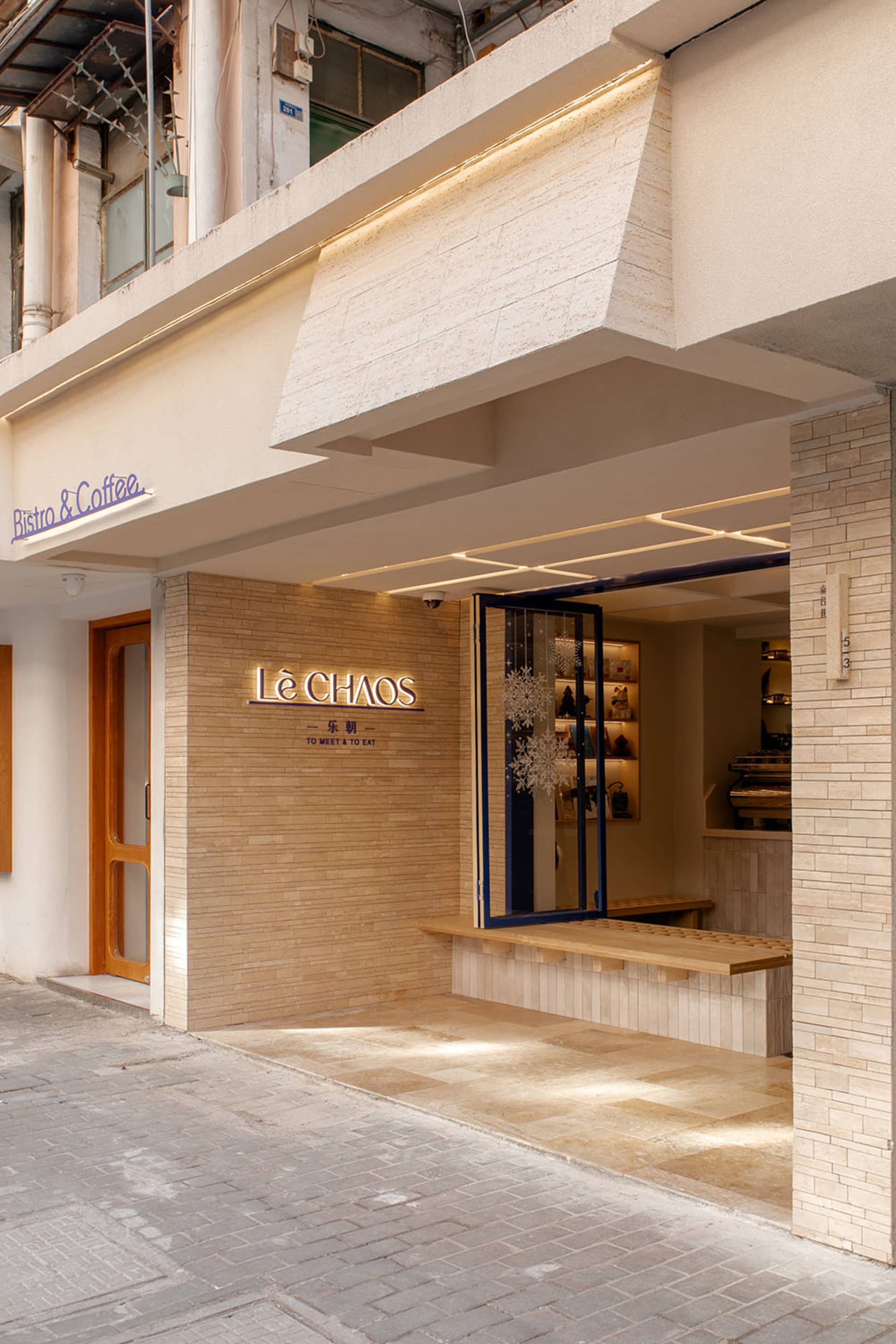 A modern cafe with brick walls, benches, and lamps creating a warm and inviting atmosphere