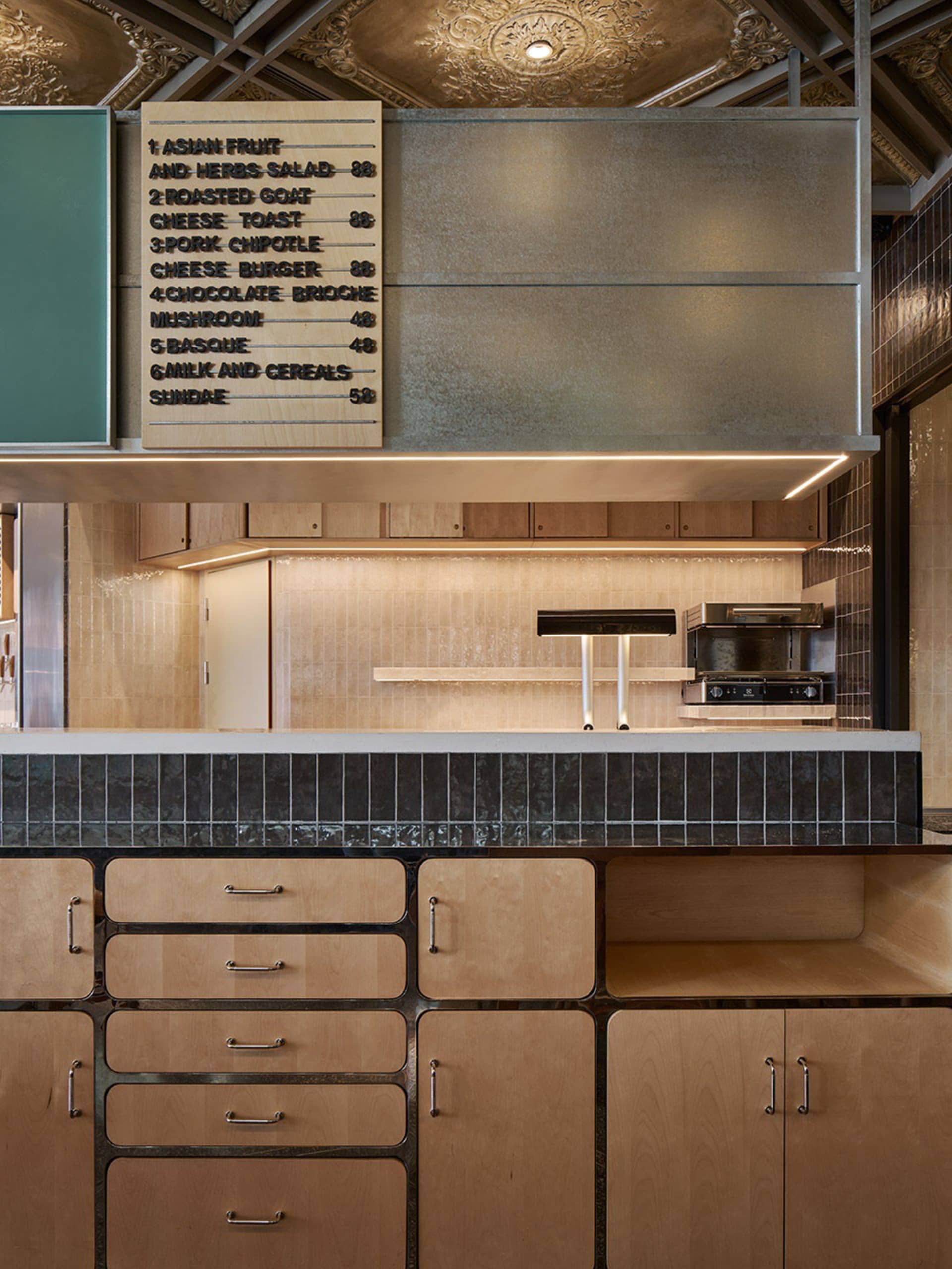 Kitchen with wooden cabinets, countertops, and appliances, featuring a casual and inviting atmosphere with a focus on food preparation and storage