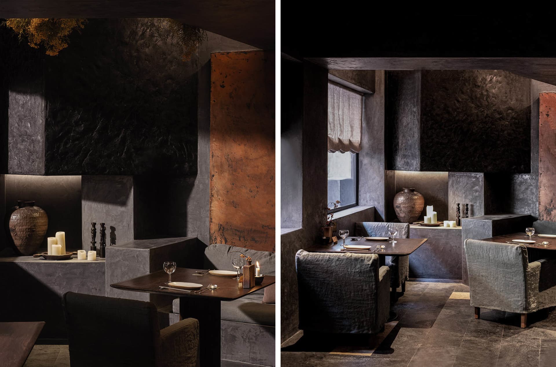 Dimly lit dining and lounge space with wine glasses, vases, and a couch near a window
