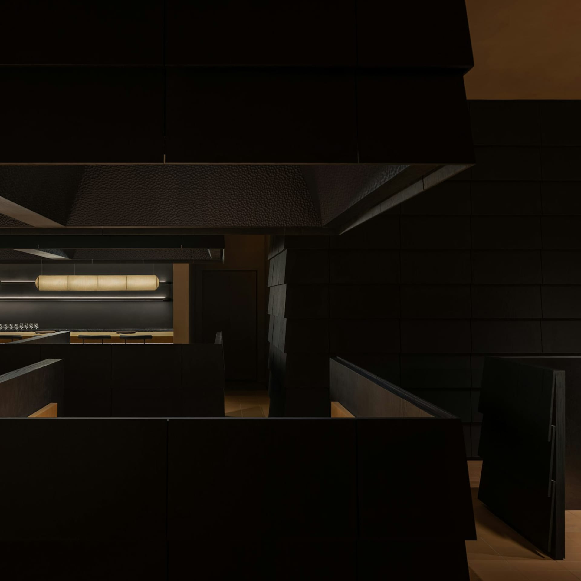 Empty modern kitchen with black walls, a refrigerator, and a sink, featuring a minimalist design
