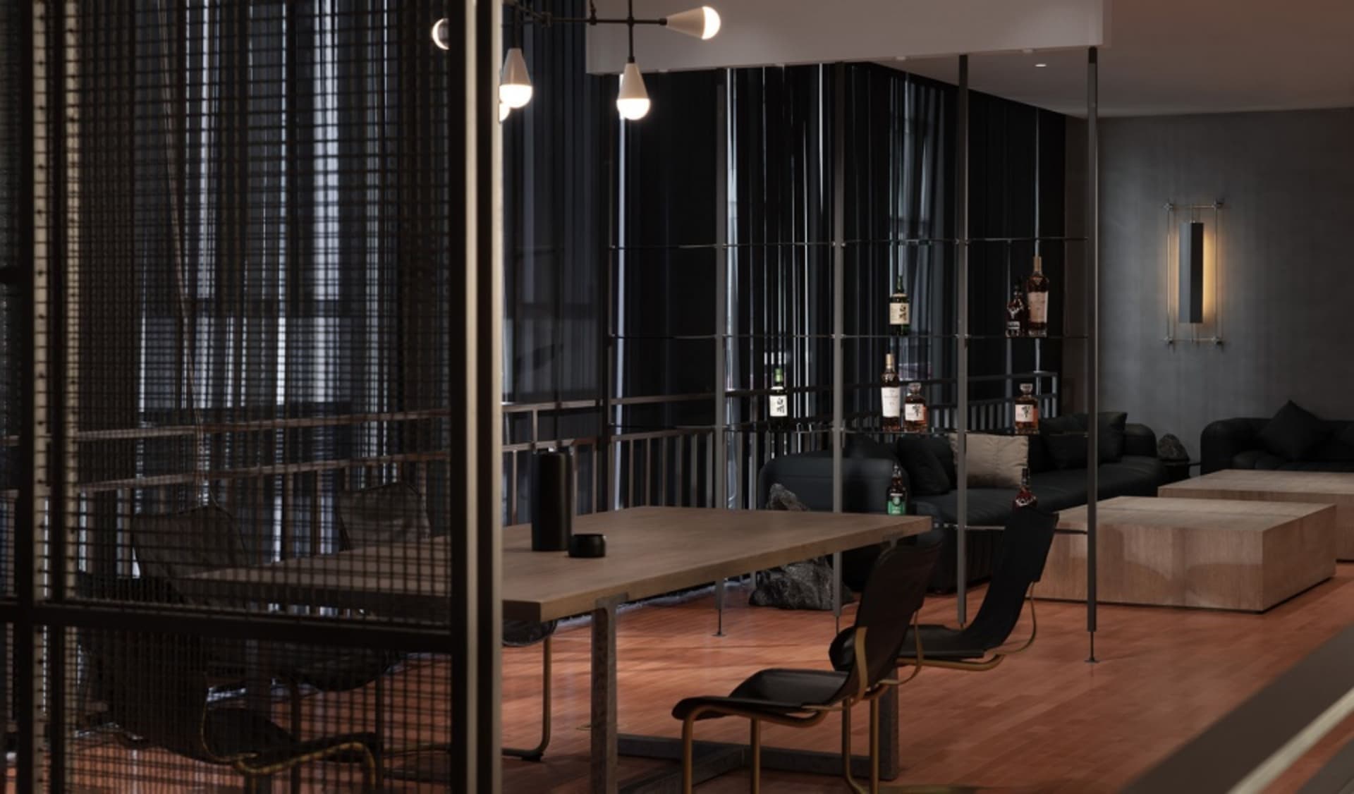 A modern office space with a wooden table surrounded by chairs, black walls, and a glass partition, creating a professional environment for collaboration and focus