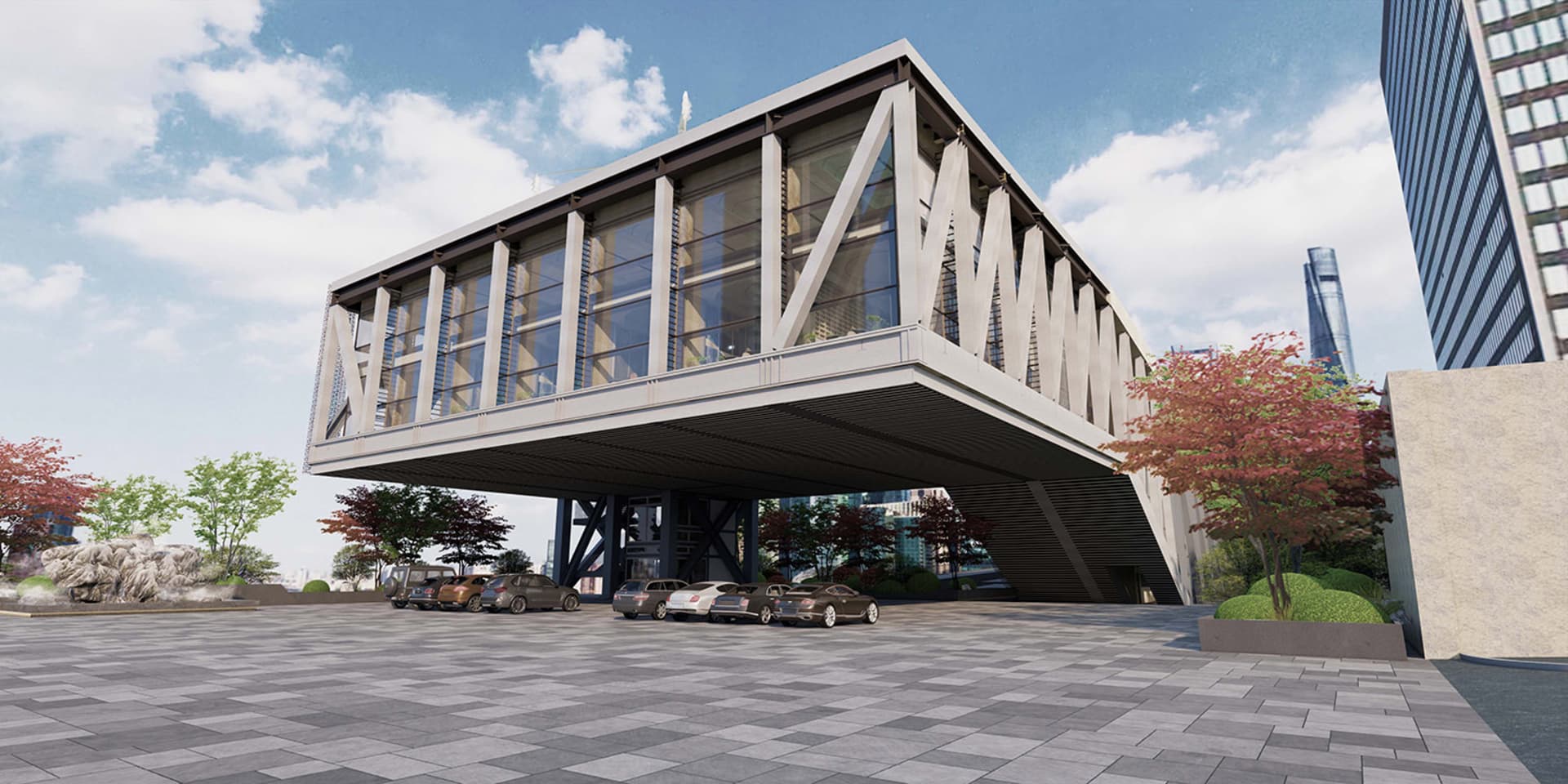 Large contemporary building with a glass facade, multiple levels, and a bridge connecting two sections, set against an urban backdrop with parked cars