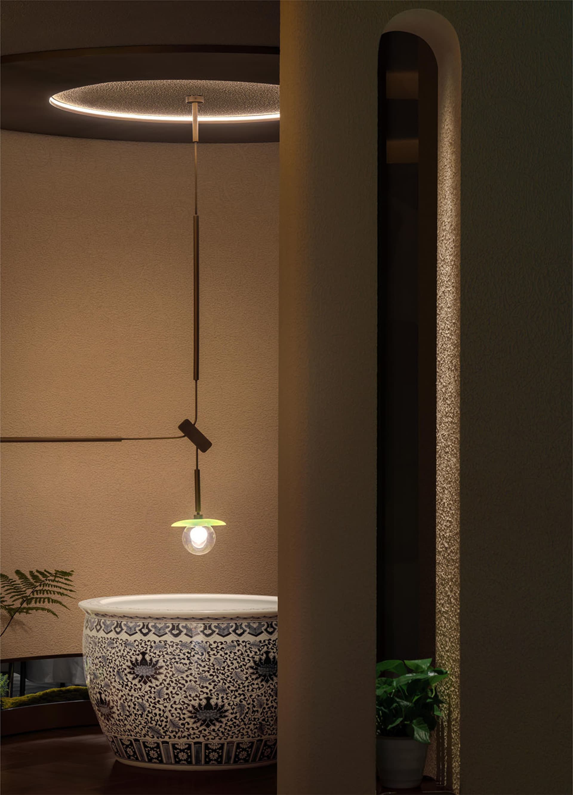 Modern bathroom with a patterned sink, a hanging lamp, and two potted plants, creating a stylish and functional space