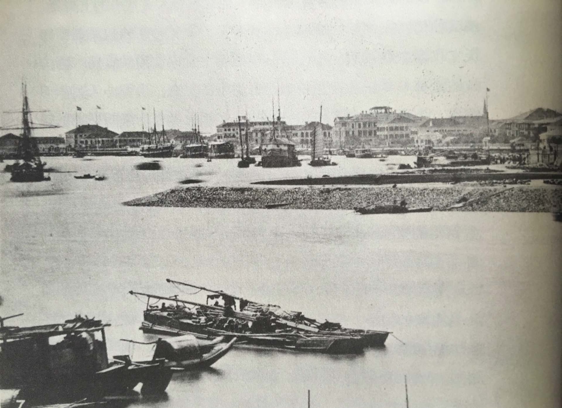 A bustling harbor filled with various boats of different sizes docked in the water, creating a scene of maritime commerce and transportation
