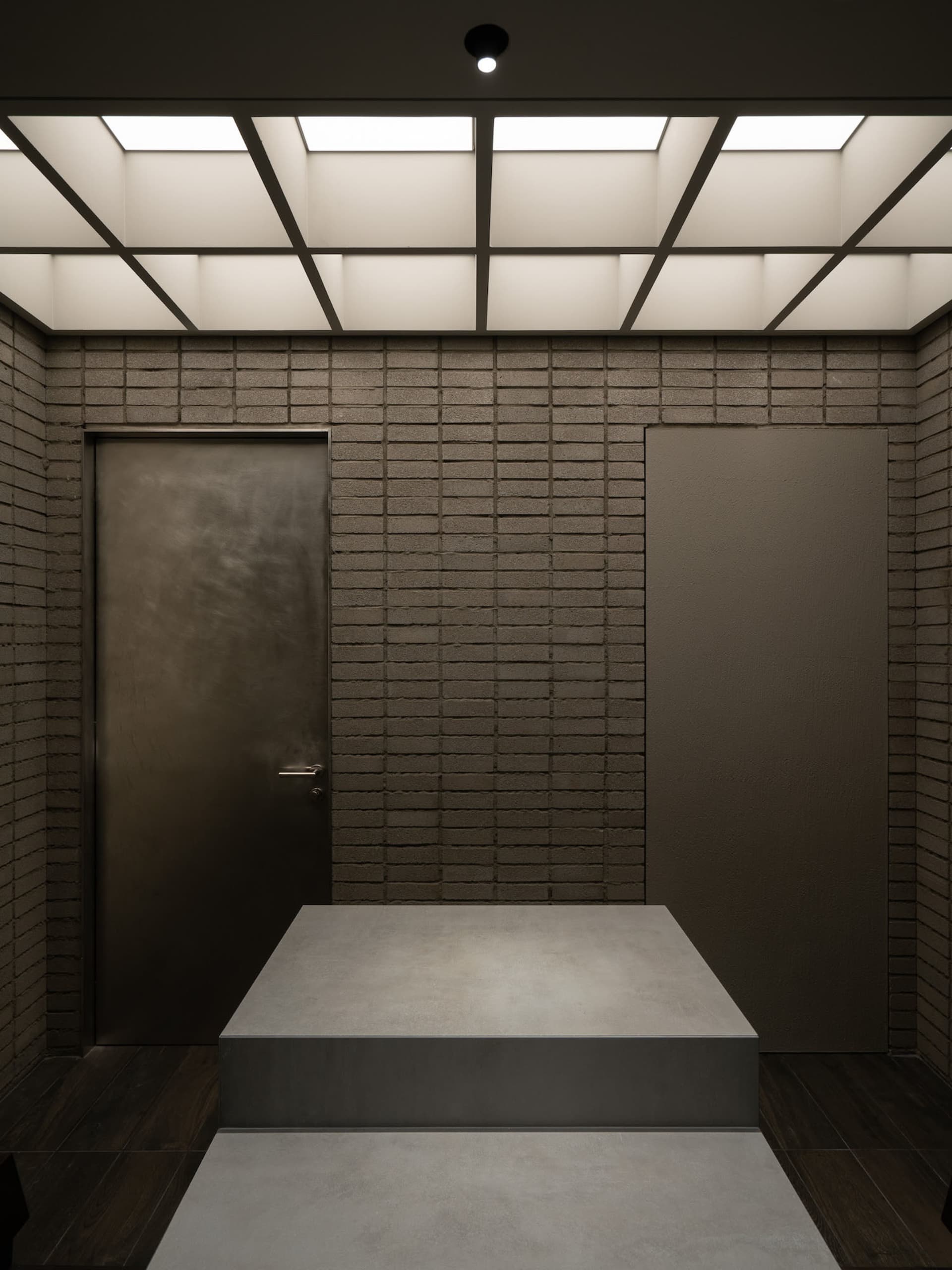 Rustic living space with brick walls, a metal table, and a doorway leading to another room
