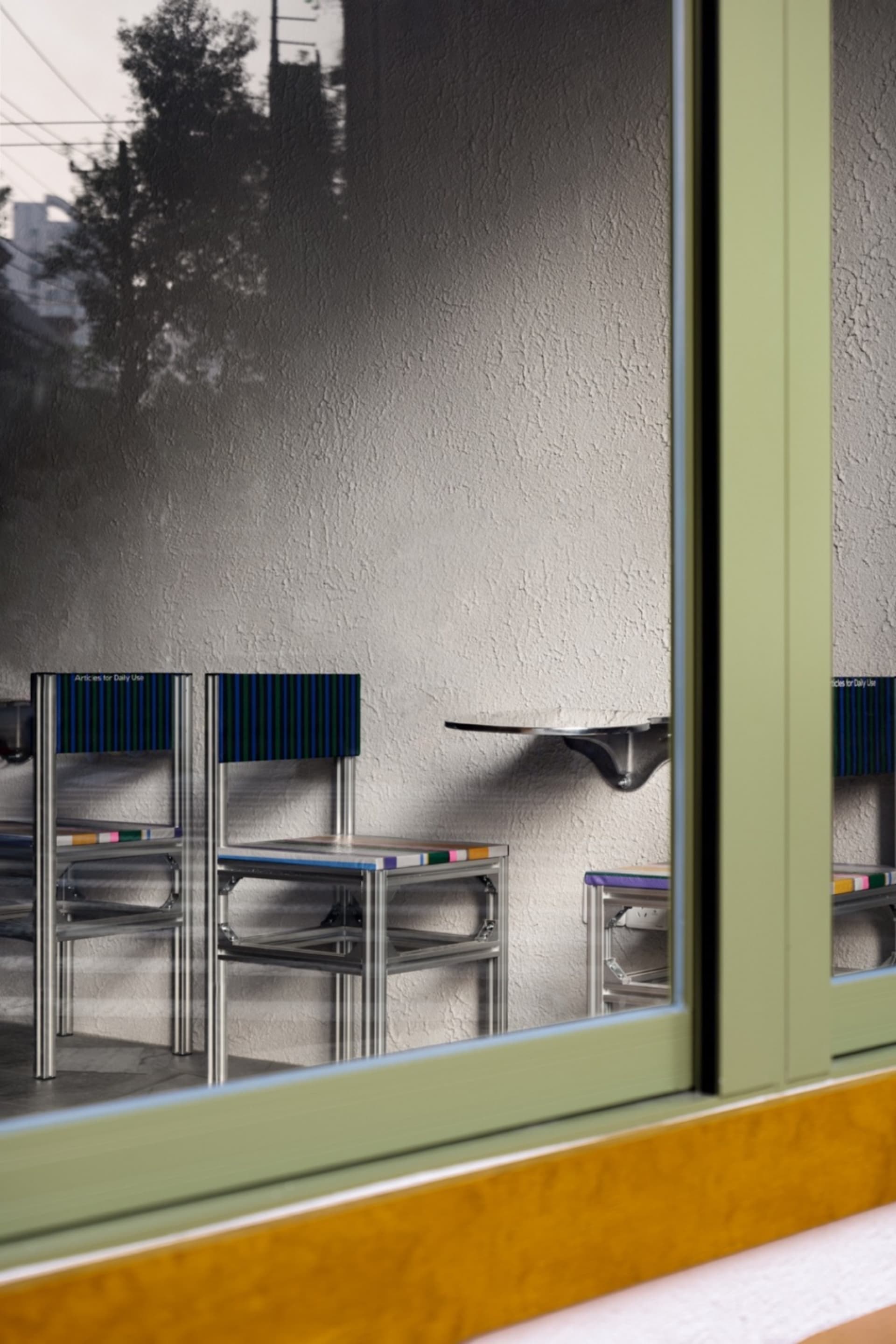 Empty classroom with metal chairs arranged in rows, creating a calm and quiet atmosphere