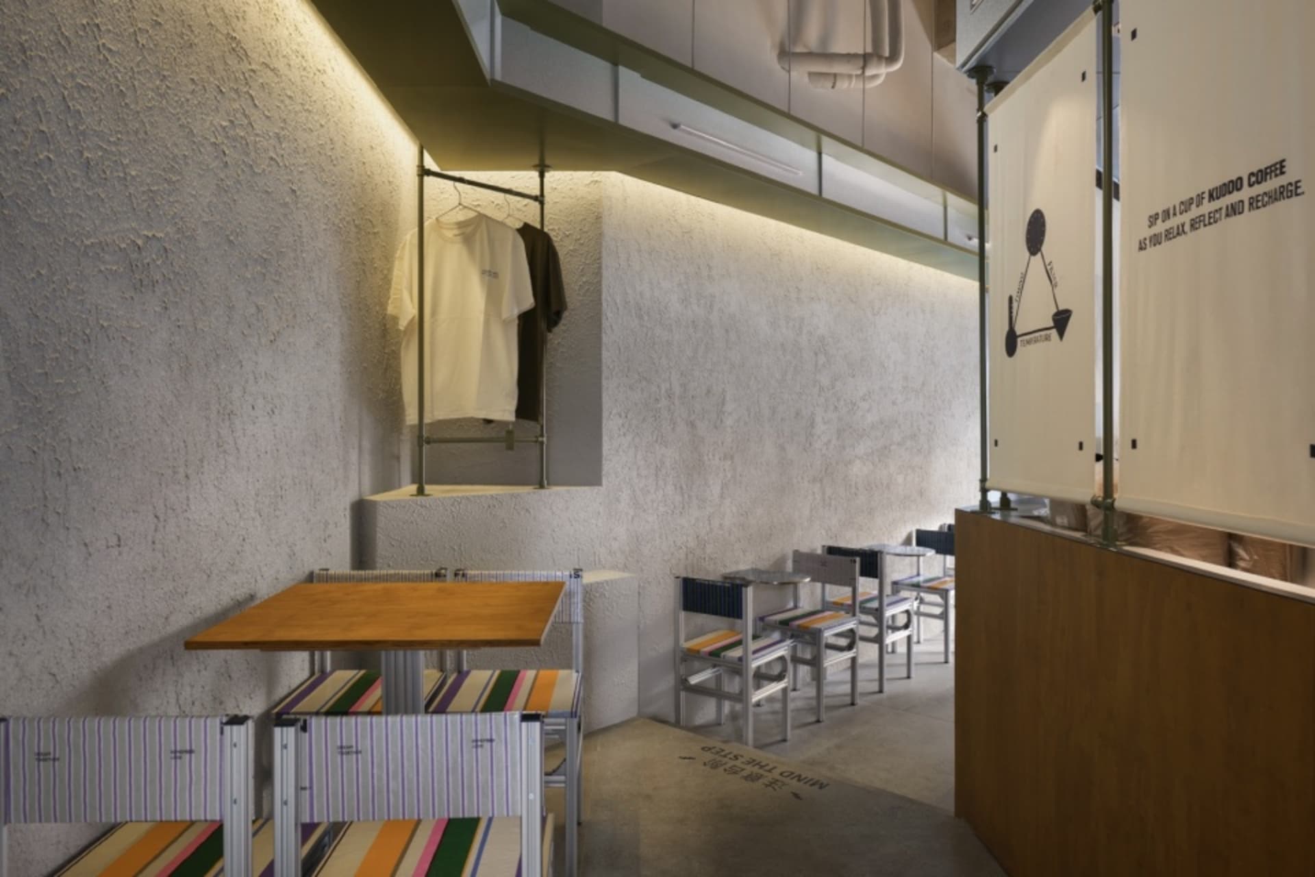 Inviting restaurant interior with multiple dining tables, chairs, and benches, creating a comfortable atmosphere for social dining