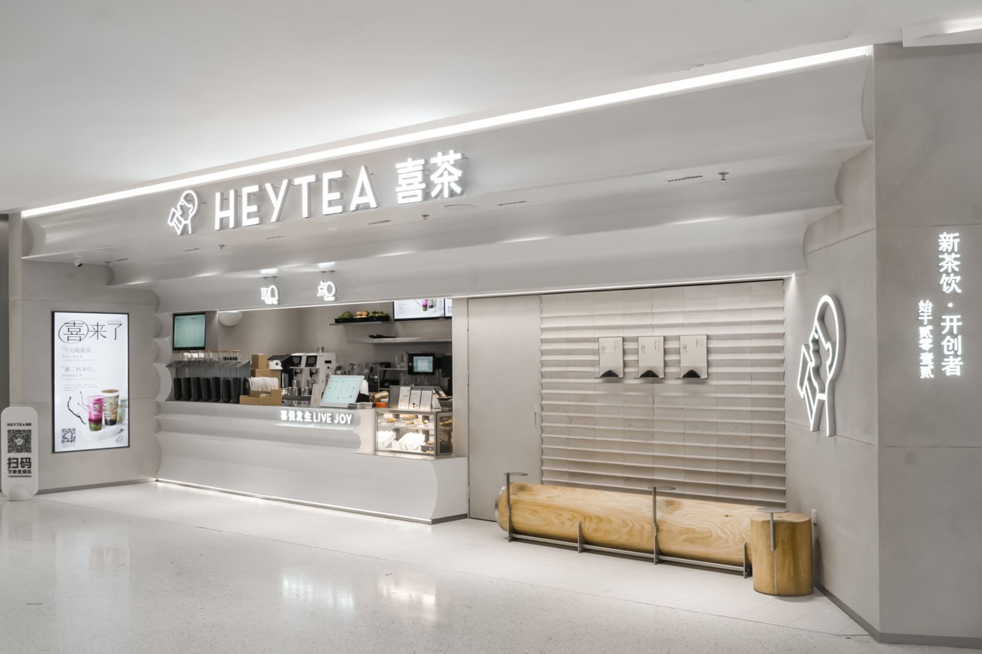 A clean and inviting Asian restaurant with a white interior, featuring a counter and dining area with chairs and tables, and cups on surfaces