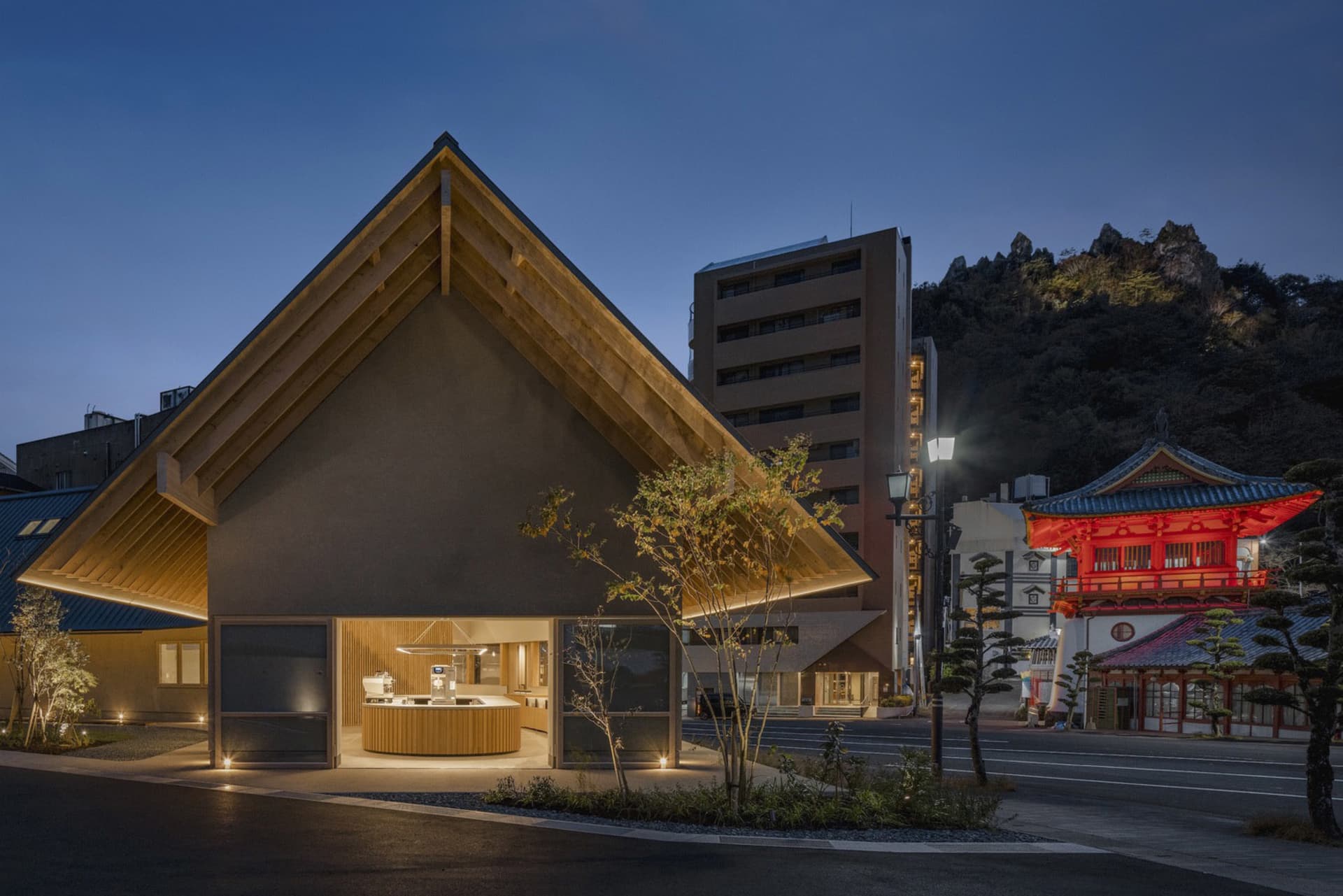 A modern house with a triangular roof and wooden exterior, featuring multiple windows and a cozy atmosphere