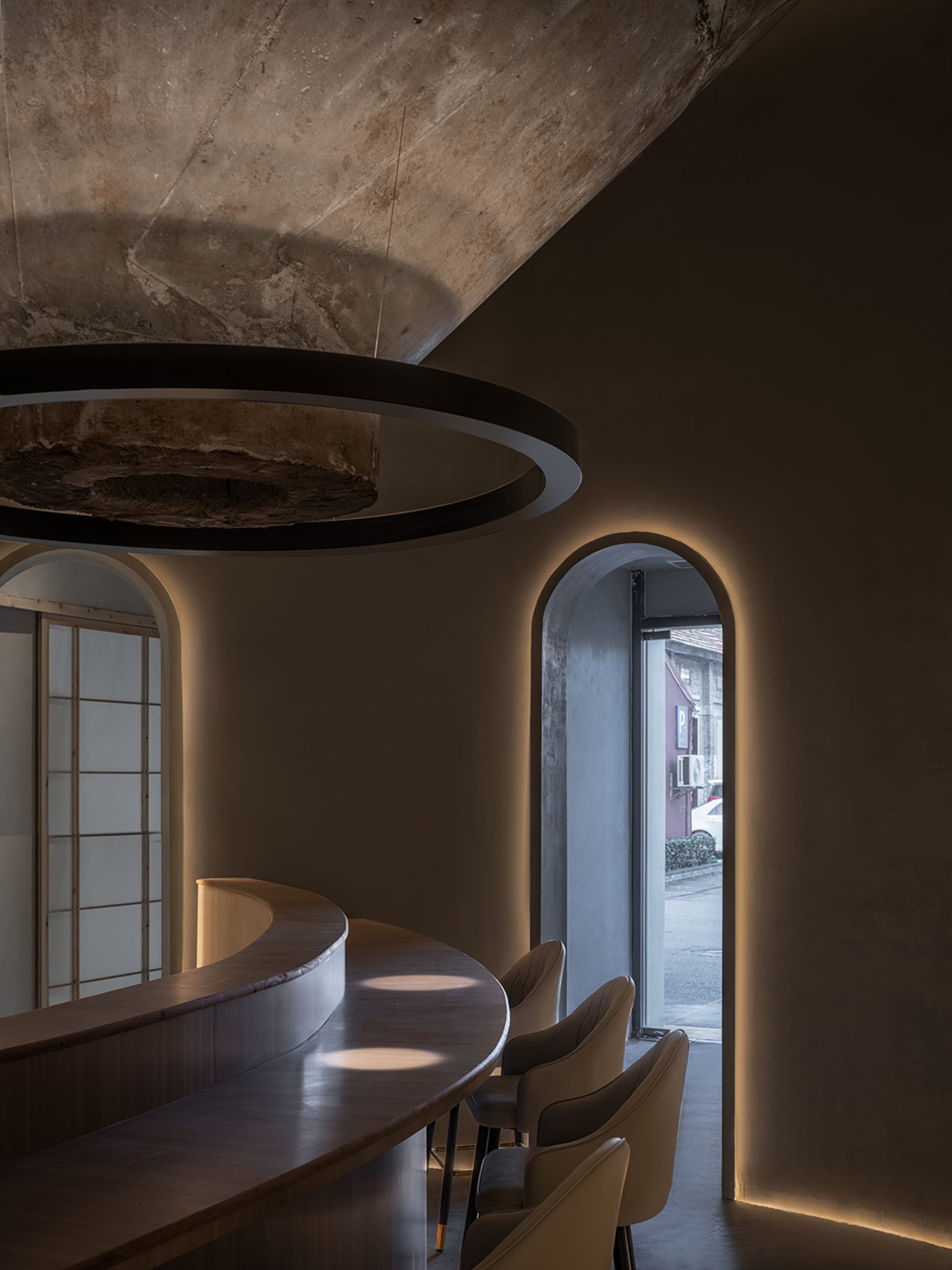 Cozy restaurant interior with a wooden counter, stone walls, and dim lighting