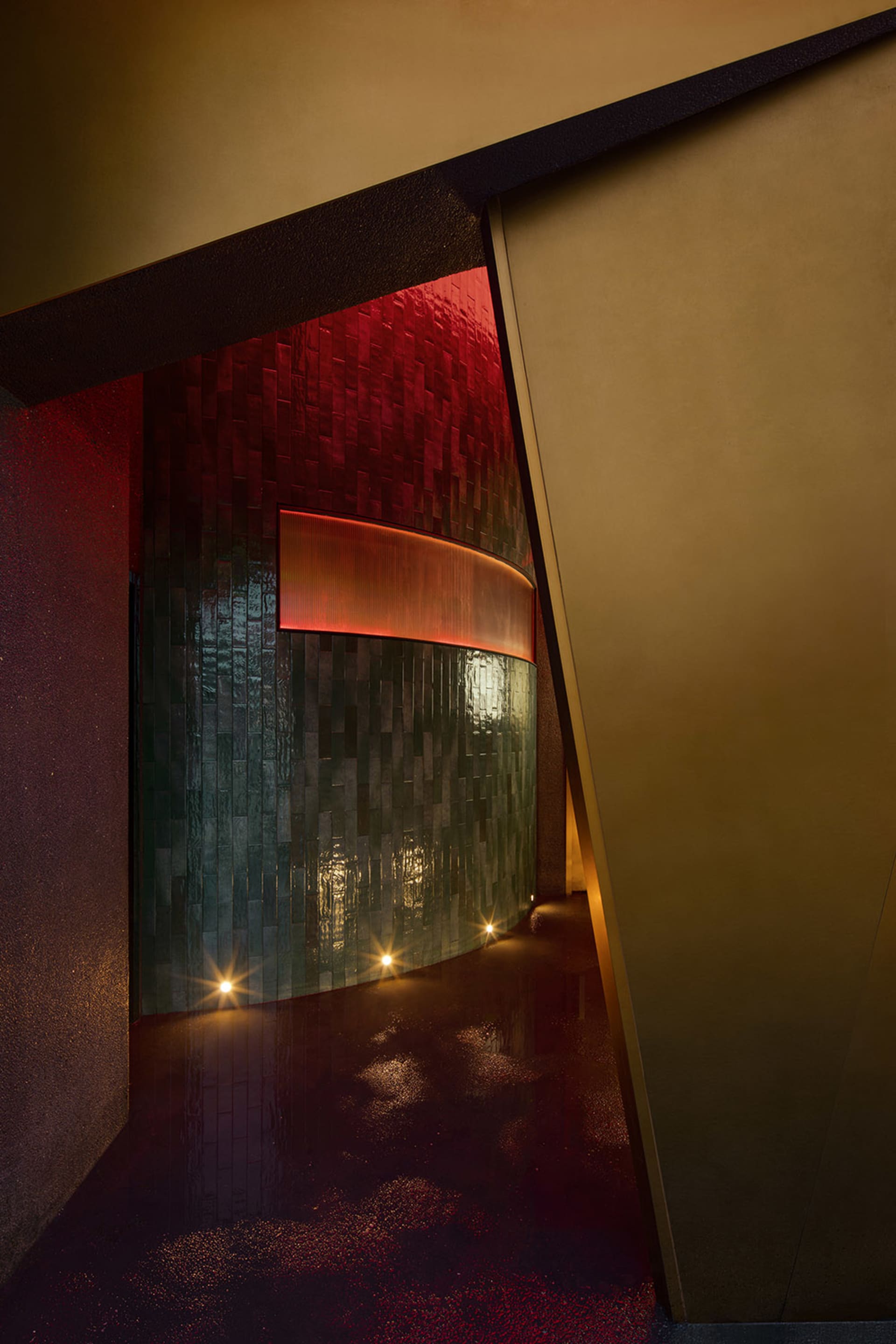 A bathroom with a red wall and a green wall, featuring a red doorway and tile-covered walls in a modern space