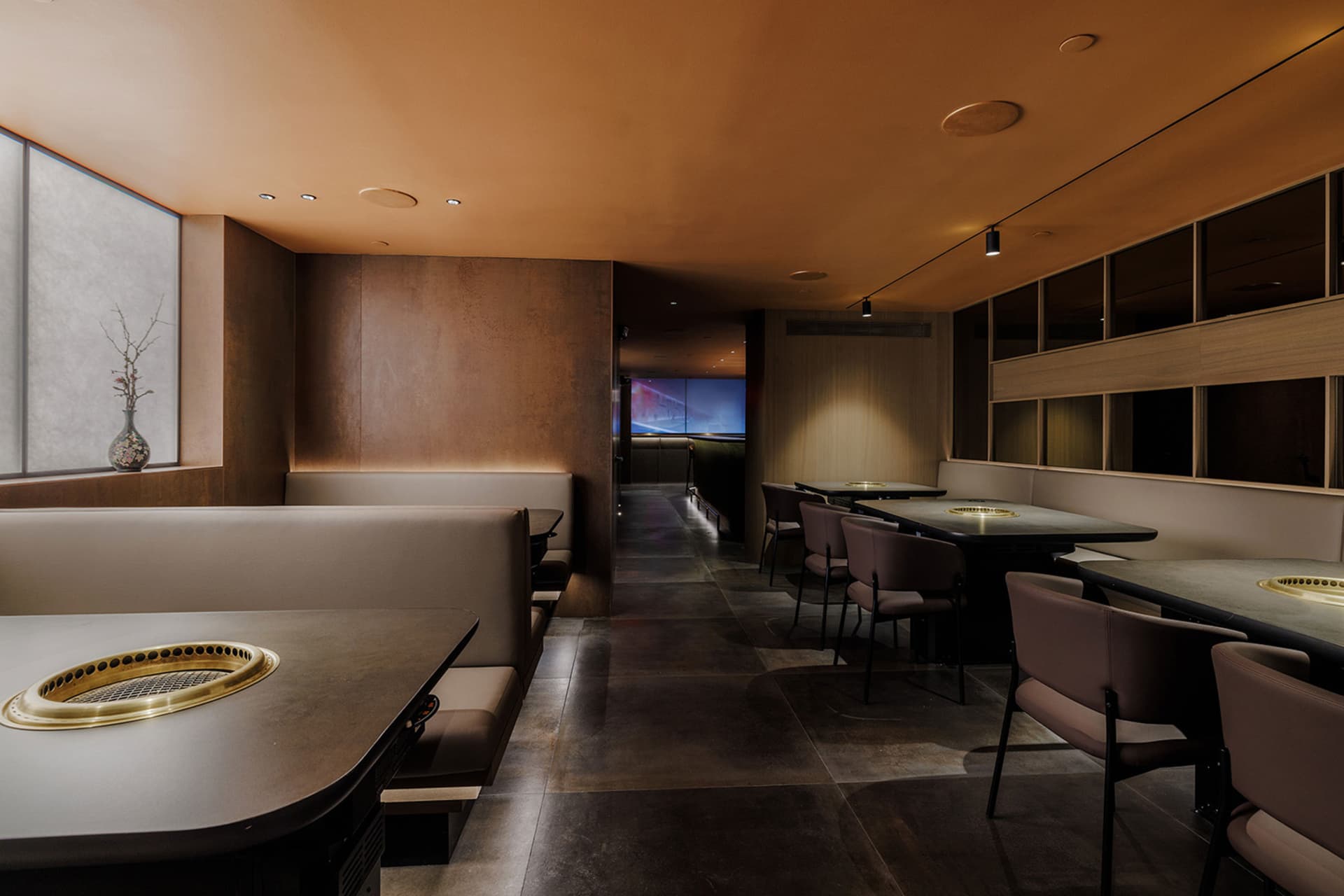 Empty restaurant with brown interior, dining tables, and chairs, creating a comfortable atmosphere for guests
