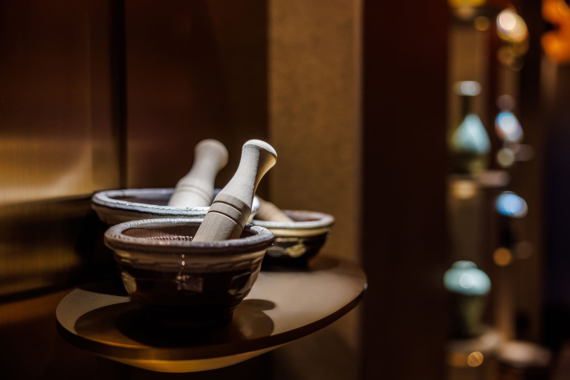 A kitchen area with three bowls on a table, creating a cozy and functional space for cooking and food preparation